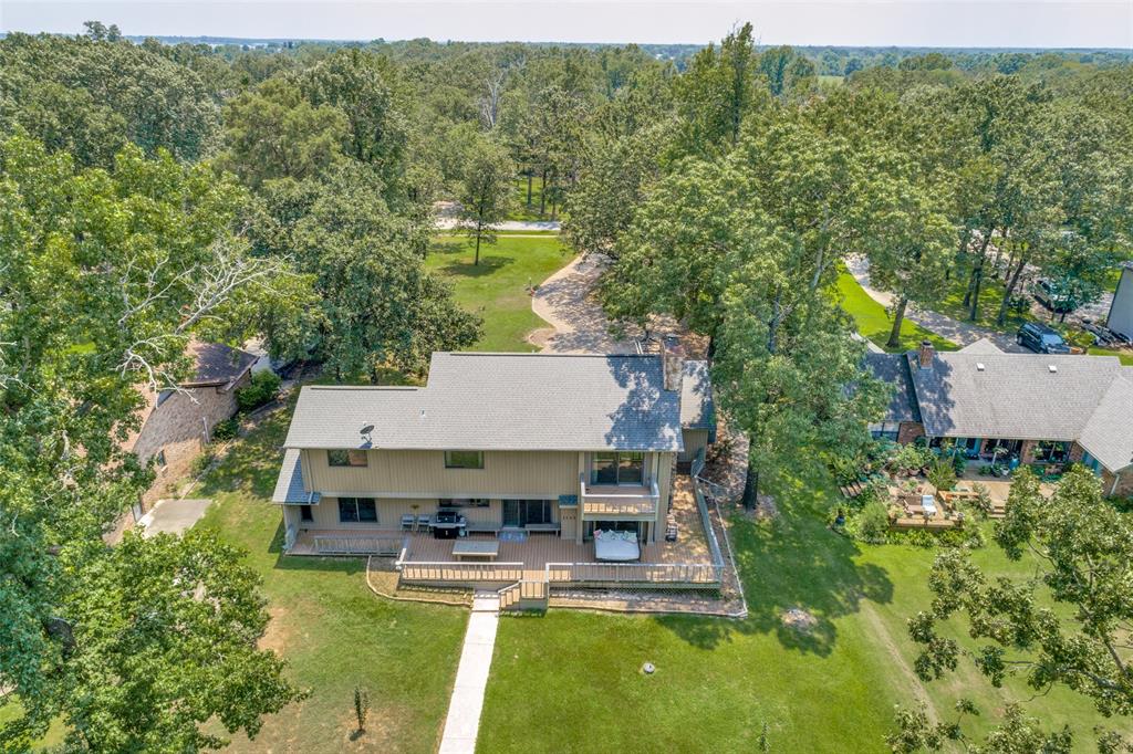 Beautiful waterfront home on Lake Fork with private covered boat house. New Bedroom added to 1st Floor.  New Cat 3 Roof.  Updated house with hardwood flooring, appliances, electrical panel and paint in the last few years so that the interior looks like a new home.  Towering mature trees all around an established small private community with a community boat ramp and a very laid back HOA. The landscaping is watered from the the lake pump to the property.  Enjoy the recent greenhouse. A 3 car garage big enough for your bass boat and toys! This is a rare lake house as the house looks great on a great lot and has a private boat dock that remained usable even when the lake water level was low a few years ago.  Buyer to verify any and all information.