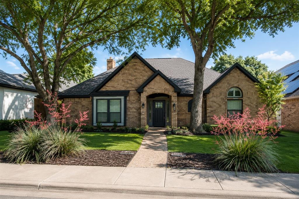 One-story home with brick exterior and charcoal paint.  Wide entryway opens to spacious dining and living areas.  
Living room features:  Built-in cabinets and shelving.  White brick fireplace with solid natural log wood mantle.  
Large windows overlooking the patio and pool.  
Primary bedroom:  Large primary suite located at the end of the back hallway off the grand living room, overlooking the pool.  stand alone shower & bathtub.  
Primary bath includes a large walk-in closet with separate his and hers sides, soaking tub, separate shower, dual sinks, large counter and storage.
Family room features:  Double doors from the grand living room.  Open concept connection to the kitchen and breakfast area.  Direct access to the pool area.  Wet bar with sink.  
Laundry room includes:  Sink & Ample storage.  
Secondary bedroom wing: Two bedrooms connected by a Jack N Jill bathroom.  One bedroom includes a large window seat.  Both bedrooms have ample closet space.  
Additional bedroom:  Separate hallway location.  Adjacent full bathroom.  Large vaulted ceiling.  
Dining room connects directly to the kitchen and enclosed patio.  
Enclosed patio is accessible from both the dining room and kitchen.  
Outdoor living features: Two tier deck.  Upper deck is stone fully covered, and includes a ceiling fan; and gas grill connection.  Lower deck is wood and ideal for sunbathing.  Heated swimming pool has a decorative stone fountain.
LOCATION:  NEAR DNT and across from park and elementary school.