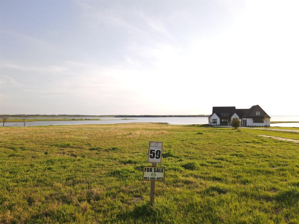 Welcome to 405 Sailview Ct, Honey Grove, TX 75446, also known as Lot 59, your opportunity to own 1.88 acres of prime lakefront property on beautiful Bois d’Arc Lake. This exceptional homesite offers the rare advantage of being boat dock capable, combining convenience, space, and luxury in one of North Texas' most desirable new lakefront communities. Whether you're envisioning a peaceful vacation home, a family-friendly retreat, or a high-potential investment property, this lot provides the flexibility and appeal to meet your goals. With short-term rentals allowed, it’s also ideal for those looking to generate income while enjoying their own slice of lake life. A newly completed home next door offers a real-world glimpse into the quality and charm of this neighborhood, giving you a clear sense of the custom home you could build here.

The Peninsula community made waves when it sold out in under 30 minutes during its May 2023 release. Residents enjoy access to a stunning multi-million dollar clubhouse featuring an infinity pool, a fitness center, a putt-putt golf course, outdoor grilling stations, and much more. Continued development is underway, with future amenities including a multi-sports field, a kayak and paddleboard launch, a fenced dog park, and multiple community marinas. The Shores at The Peninsula is also moving forward, with the first community boat slips already under construction and more amenities expected by summer. From Lot 59, you'll take in sweeping views of Bois d’Arc Lake, the planned Belle Vie and Five Points communities, and the expanding amenity area of The Shores at The Peninsula.

This is your chance to be part of an exclusive lakeside community that’s quickly becoming one of the most sought-after destinations in North Texas. Don’t miss out on the opportunity to own at Bois d’Arc Lake and experience a lifestyle that blends natural beauty, luxury living, and lasting value.

Buyer to verify all information*