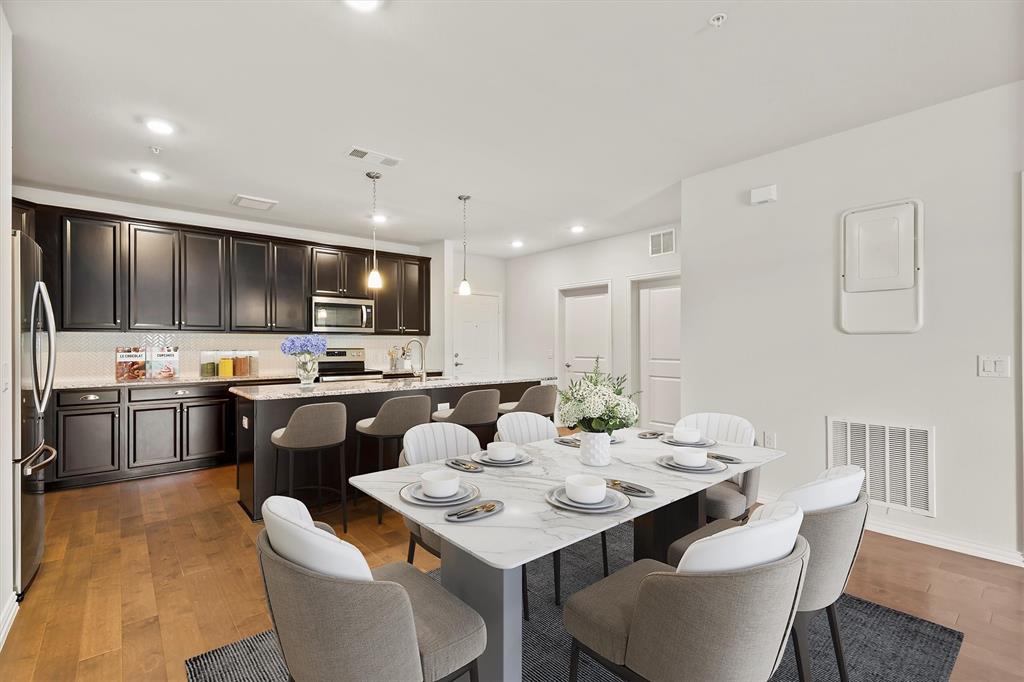 LOCK AND LEAVE lifestyle in this Active Adult 55+ community. Enjoy secured access and a beautiful lobby entrance with exterior maintenance provided. This Dorset plan features an open concept floorplan with 9' ceilings throughout, stainless steel appliances, granite kitchen countertops with designer backsplash. Kitchen has large walk-in pantry and beautiful island with room for seating leading into the dining and living areas. Wood flooring in all common areas with upgraded carpet in both bedrooms and blinds on all windows.  Condo is on the second floor with easy access to the elevator and a view of the fabulous amenity center just across the parking lot. Community includes beautiful swimming pool, fitness center, pickleball court, grilling stations, putting green, community garden boxes, yoga and event lawn and a picnic with fire pit area. Homeowner frequently organized events, dog park and weekly front door trash valet. HOA fee includes Hazard Insurance for buildings, landscaping, secure access, elevators and common area maintenance. Detached over-sized one car garage. Close to shopping, restaurants and major highways.