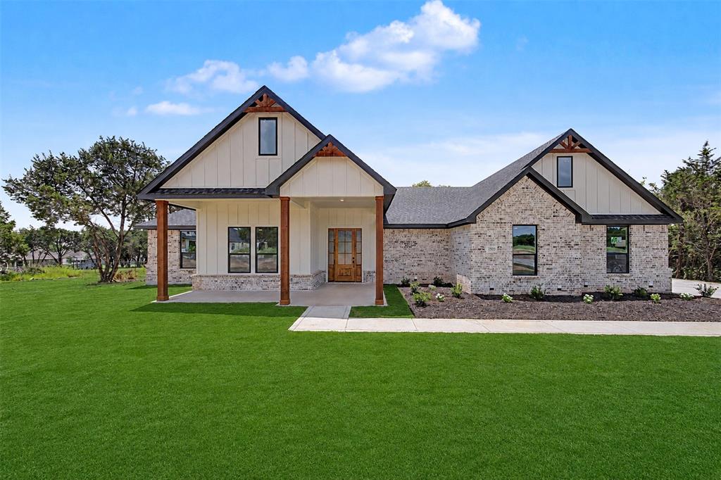 Discover your dream home in the picturesque Westover Hills community in Rio Vista, Texas where luxury, space and country living come together. Nestled among beautiful, wooded landscape on a one-acre lot, this stunning new custom home offers 4 spacious bedrooms, 2.5 well designed bathrooms and an oversized 2 car garage. The curb appeal of this home is impressive, with a welcoming covered front porch perfect for enjoying the Texas sunrises. The wood entry door with insulated glass leads to the large living room, soaring ceilings, abundant natural light and custom details throughout. At the heart of the home is a chef-inspired kitchen featuring a massive center island, quartz countertops, a 48-inch stainless steel gas range, a beverage cooler, a pot filler, self-closing cabinetry and an open-concept design perfect for entertaining. Just off the kitchen, you will enjoy an oversized walk-in pantry, complete with additional countertop workspace and extra cabinetry to keep your kitchen beautifully organized. Two fireplaces provide year-round atmosphere, one in the living room for cozy evenings and one on the covered back patio perfect to enjoy the countryside. The master suite, is a true sanctuary, featuring box ceilings, double vanities, a separate shower, an ensuite bath with a soaking tub and an expansive custom closet. Three splits bedrooms, a full bathroom with dual sinks, a half bathroom and convenient luxury vinyl plank floors complement this home. Pet lovers will appreciate the generously sized utility room, featuring a dog wash station making it easy to clean up your furry friends. For comfort and convenience this home is equipped with remote control ceiling fans and open cell spray foam insulation. Located approximately 45 minutes from the DFW Metroplex, this community invites you to embrace the tranquility of small town living, while enjoying the convenience of modern amenities. Don't miss this opportunity to enjoy scenic views and to create your own oasis.