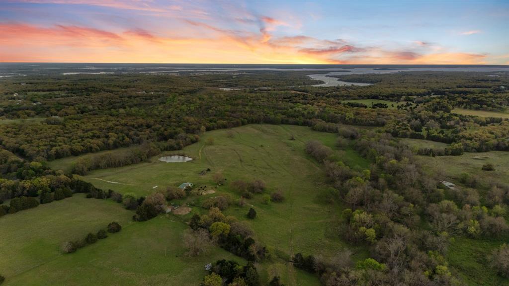 Welcome to an extraordinary luxury ranch retreat and investment opportunity at 3647 County Road 265 in Collinsville, Texas—where privacy, scale, and natural beauty converge across more than 73 acres of prime North Texas land.

A picturesque private driveway leads you into a secluded setting defined by rolling hills, dramatic elevation changes, and sweeping prairie views. This property offers a rare blend of refined rural living and long-term investment potential, ideal for a private estate, luxury retreat, recreational ranch, or future development hold.

The land features a tranquil pond, enhancing both the aesthetic appeal and functional value for livestock and wildlife. With multiple elevated build sites, the property is perfectly suited for creating a custom luxury residence or multi-structure retreat compound designed to capture panoramic views in every direction.

Adding to its exclusivity, the property adjoins over 140 acres of Army Corps of Engineers land, providing extended privacy, protected surroundings, and a natural buffer that significantly enhances long-term value.

From an infrastructure standpoint, the property is fully fenced, including approximately 1,000 feet of pipe and metal fencing, and is already equipped with water and electricity on-site—a major advantage for immediate use or future development. A storage structure for tractor and equipment is included offering turnkey functionality for ranch operations or land management.

Whether you’re seeking a private luxury escape, a weekend retreat with income potential, or a strategic land investment in a rapidly growing North Texas corridor, this property delivers a compelling combination of beauty, utility, and upside.