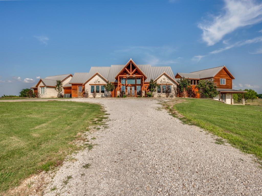 Multi level home on acreage with lake views from your living and bedroom , stone home with metal roof property ag exempt , great access to interstate and the Lake and state parks , The media room is also a safe room ,Custon built home on acreage room for cattle , horses great location with so much in the area , minutes away from the state park entrance