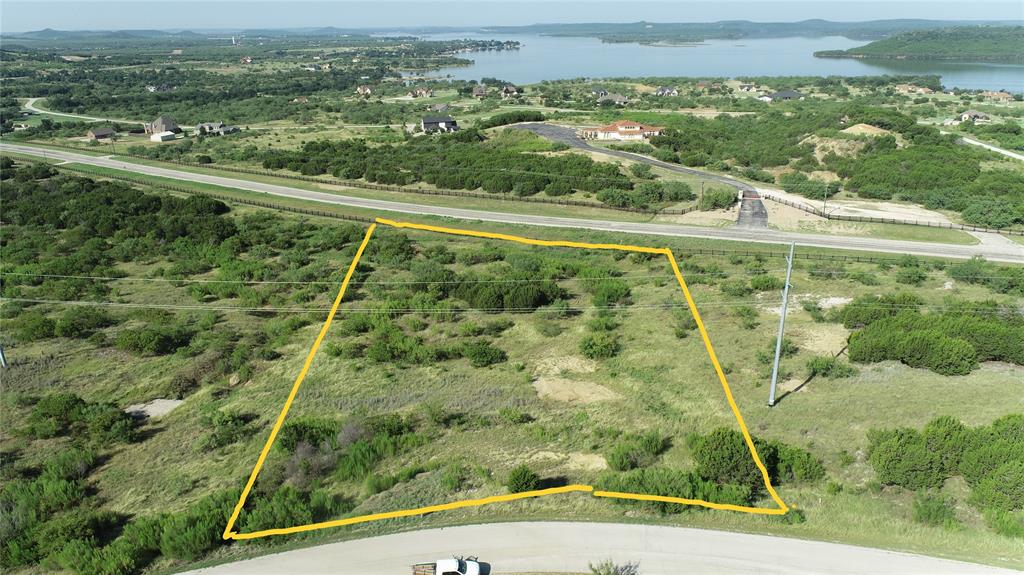 AMAZING LAKE VIEWS from this two acre lot at The Hills above Possum Kingdom Lake. Best seen in person! This lot is very close to the main gate 3 for ease of access to the pool, clubhouse, fitness center and lake cabin. Build on your own timeframe with your own choice of builder. 2500 sq ft minimum home. You can build a secondary building on this property. No manufactured homes and No metal homes like barndominiums are allowed. No RVs can be parked on the lot during construction. The roads in this development are all asphalted. While you are waiting for your home to be built you will enjoy the upscale amenities that are included in the low annual POA dues of $950. This includes the gorgeous community clubhouse infinity swimming pool, fitness center with commercial grade equipment inside the cluhouse, serene lake Ritchie cabin with dock and watercraft launch, boat storage, and community pond. Electric and water are available at the property. The stars are brighter out here in the dark skies of PK Lake. You will enjoy the sights and sounds of nature all around including deer, roadrunner, turkery, owls, and more. Summer fun is here and this is a great time to come out and start creating your family memories! Annual Hells Gate Fireworks Show is on Saturday July 4th this year.