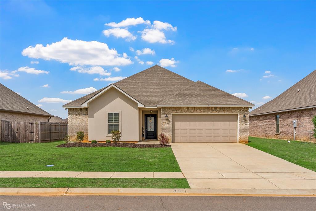 ONLY 3 YEARS OLD IN DESIRABLE HAUGHTON! Legacy Pointe is one of Haughton's fastest growing subdivisions in a convenient location and at great price point. 107 Vienne Trace offers 3 bedrooms, 2 bathrooms, 1514 square feet, and a 2-car garage. Step inside to find beautiful neutral colors and a welcoming foyer with a spacious coat closet. To the left you'll find two secondary bedrooms each with ample closet space and the second bathroom. As you enter the living area, you'll be greeted by an abundance of natural light and a flowing open concept layout ideal for simplified daily living or entertaining guests. The wood-look ceramic tile is low maintenance and can stand the test of pets and kiddos. The kitchen has stainless steel appliances, granite countertops, an electric range oven, pendant lighting, a pantry, and an island with room for bar stools. The primary suite has an ensuite bath with a walk-in closet and a large tub-shower combo. The back patio is covered and has plenty of room for rockers or your grill. Legacy Pointe provides easy access to I-20, Barksdale Air Force Base, North Bossier shopping and dining, Haughton conveniences, and excellent public schools. This home is ready for you to call it HOME!