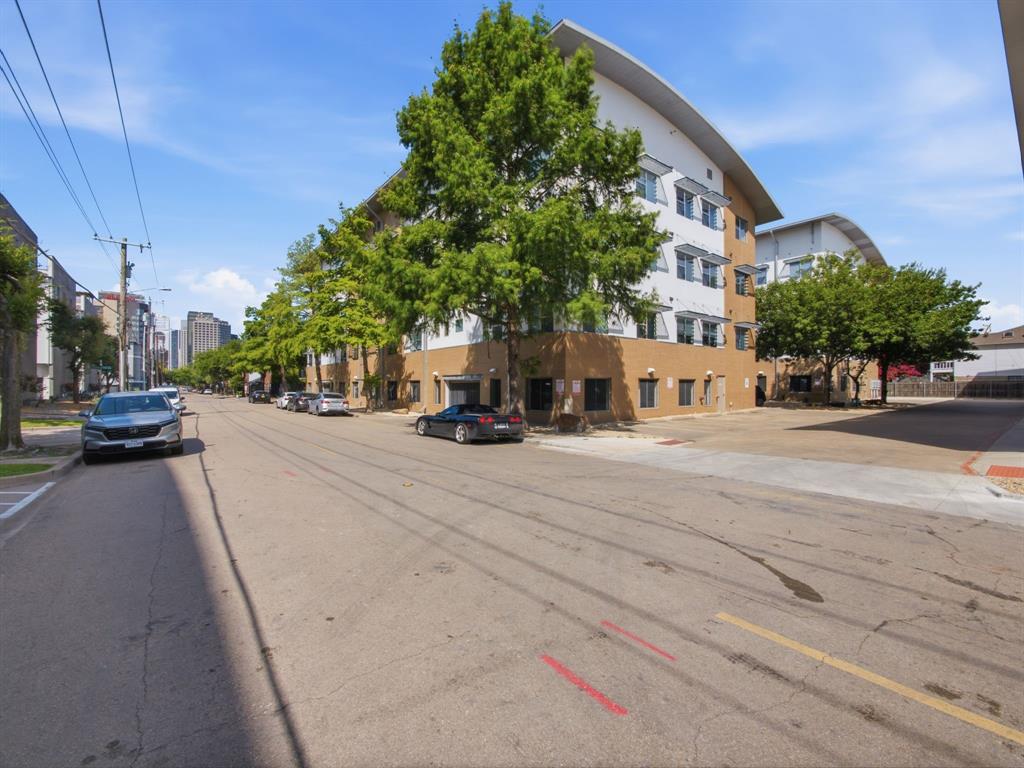 Just East of downtown.  First floor is the gated parking garage, so this is actually the third floor, but building has an elevator.  Designed for low maintenance living and close to Exall park, Downtown, Uptown, Deep Ellum, major highways, and Baylor Hospital.  10Ft ceilings and lots of natural light.  Kitchen has white cabinets, dishwasher, microwave, and electric stove.   Wood in living room.  Large one bedroom with on suit bath with garden tub and walk in closet.  This unit has a separate deeded 2nd parking spot that is included.  Centrally located home provides the best of city living with easy access to parks, trails, dining, and entertainment.  Refrigerator included.
