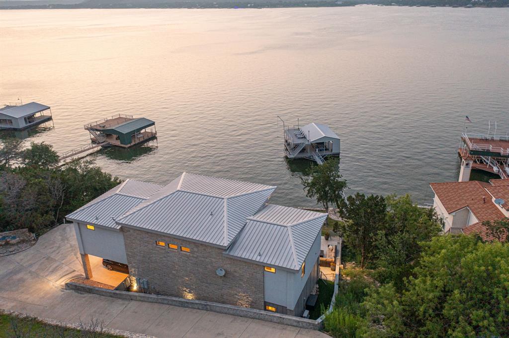 Lakeside luxury meets nature’s masterpiece.
Perfectly perched on the deep, clear waters of Possum Kingdom Lake, this rare waterfront escape delivers jaw-dropping views and year-round enjoyment. Fully furnished and move-in ready, the home boasts an airy open layout, floor-to-ceiling windows, and seamless indoor-outdoor flow that puts lake life front and center.

With 3 oversized bedrooms—each with a private bath—and a flexible 4th room ideal for a bunkroom, game room, or extra guests, there’s room for everyone. The spacious primary suite offers panoramic lake views and direct access to the expansive deck.

Outside, enjoy your own private pool and an elevated deck built for sunset cocktails or stargazing. The custom dock features a party platform, green fishing lights, upgraded walkway lighting, and all-weather decking that cleverly converts to a hangout zone when your PWC is out.

Don’t just live by the lake—own the experience.

Thoughtful updates since its last market appearance make this turn-key home ideal for immediate enjoyment. Don’t miss the opportunity to own one of the few deep-water properties at Possum Kingdom with both privacy and a front-row seat to the lake’s beauty.