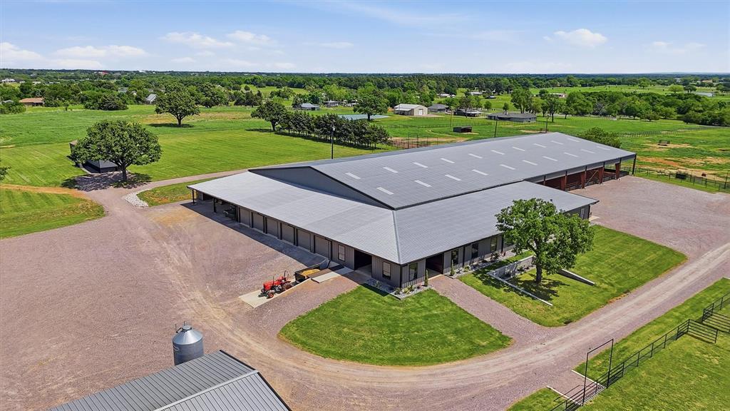 A truly exceptional equestrian estate offering world class facilities & unmatched infrastructure. Experience a blend of functionality and professional grade equine amenities at this premier horse property. Thoughtfully designed and meticulously maintained, this estate delivers a turnkey operation for the discerning trainer, breeder, or equestrian enthusiast seeking excellence at every level. The centerpiece of the estate is a state of the art, 25 stall show barn designed for efficiency, comfort, and high-performance care. Oversized stalls with automatic waterers and feeders, dual wash racks, a convertible stock area, dedicated tack and feed rooms, full laundry, and a climate minded spray foam envelope elevate daily operations. Six roll up doors, a concrete loading dock, a polished half bath, and a private lounge-office complete this professional grade facility. Separate utilities and expansive trailer parking further enhance convenience. A 125x250 indoor arena provides year round training opportunities. A 6-horse walker & 52’ round pen (both negotiable) offer additional versatility for conditioning and groundwork. The 35x60’ hay barn, a grain silo, and adjacent cinder block manure pit ensure efficient storage and management. 4 large pastures  equipped with loafing sheds, catch pens, stocks, and automatic waterers offer safe, functional turnout. Horizontal alleys, connecting gates, 10 tie poles, and 3 additional turnouts near the show barn create exceptional flexibility. An unfenced pasture area with water lines already in place provides room for expansion or future development. The updated 1,191 sq ft residence offers 2 bedrooms, 2 baths, a new 2024 roof and a detached two car garage with utilities. A 3 bed, 2 bath mobile home provides staff living quarters. A 2,884 SF 4 bed, 3 baths additional updated residence offers a separate entrance with its own 40 x 60 workshop, half bath and storage building, office or flex space. Call for an appt!