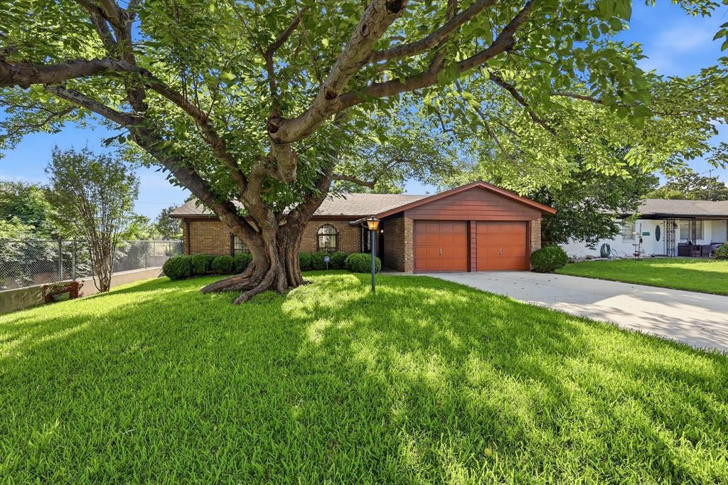 This charming brick ranch in Watauga has a backyard that'll stop you in your tracks!

Nestled under the shade of a magnificent mature tree, this solid all-brick, single-story home at 6325 Stardust Dr N offers incredible bones and a rare opportunity in the heart of Watauga. Sitting on a generously sized lot, this 3-bedroom, 2-bath home features a functional single-story layout with a 2-car garage and a foyer entry that leads you right into the heart of the home.

The spacious living room anchors the floor plan, with a dining area just off the galley-style kitchen, which surprises with granite countertops, abundant cabinetry, and a stainless dishwasher already in place. The primary bedroom is tucked away for privacy and includes a walk-in closet, while two additional bedrooms offer flexibility for family, guests, or a home office.

Step outside and you will understand why this lot stands out. The backyard is a dream canvas, featuring sprawling green space, a storage shed, mature trees for natural shade, and a patio area ready for your vision. Whether you are an investor looking for your next project or a buyer ready to add your personal touch, the value is here.