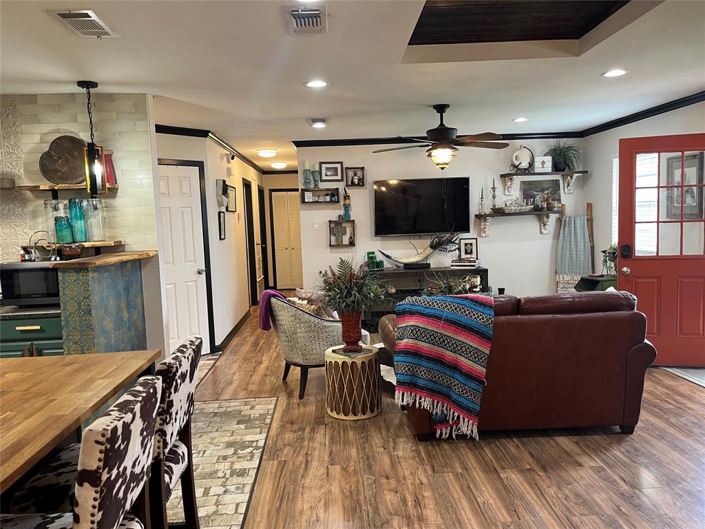 Nestled on a desirable corner lot in the heart of Granbury, this charming 3-bedroom, 2-bath home offers the perfect blend of character, location, and opportunity. Situated within the Historic Overlay District—only area in Granbury eligible for short-term rentals—this home presents a rare investment opportunity or an ideal primary residence.

Recently transformed into the cutest rustic eclectic retreat, the home is full of personality and warmth, with thoughtfully curated finishes that create a cozy yet stylish atmosphere. Whether you're looking for a full-time residence, weekend getaway, or income-producing property, this one checks all the boxes.

Enjoy being just a short 10-minute walk to the vibrant Granbury Square, where there’s always something happening—from local festivals and live entertainment to boutique shopping and dining. Recognized by USA TODAY as the Best Historic Small Town in America multiple times (2019, 2020, 2021, and again in 2025), Granbury continues to charm visitors and residents alike with its lively community and rich history.

Tucked in a quiet and cozy central neighborhood, the property also features a truly unique garage expansion—complete with original rails and door still intact—adding character and versatility you won’t find anywhere else.

This is your chance to own a piece of Granbury’s historic charm with modern-day flexibility. Come experience it for yourself!