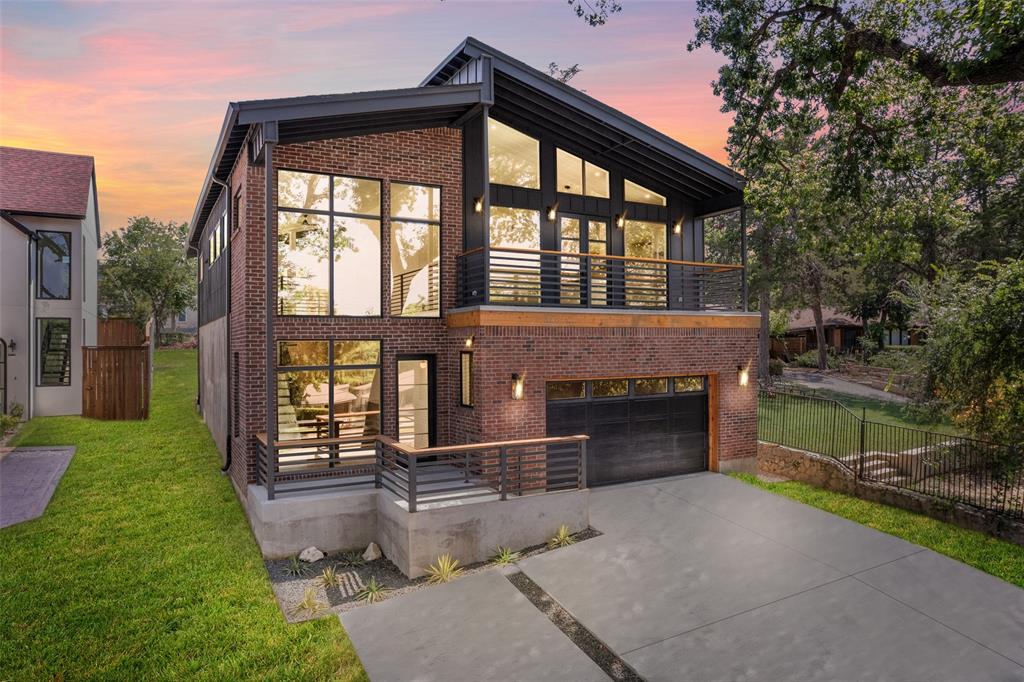 Welcome to this beautifully crafted custom home, perfectly nestled on an oversized, heavily treed lot that seamlessly blends nature with modern luxury. Expansive windows throughout the home invite abundant natural light and breathtaking views, creating a serene retreat in the heart of the city. Inside, you will find an open-concept design with high-end finishes, soaring ceilings, and thoughtfully curated details that exude elegance and comfort. The spacious living areas are perfect for entertaining, while the gourmet kitchen boasts premium appliances, sleek countertops, and ample storage. The primary suite is a private oasis featuring a spa-like ensuite bath and generous closet space. Additional bedrooms offer flexibility for guests, home offices, or creative spaces. Step outside to enjoy the lush backyard, ideal for relaxing or hosting gatherings under the canopy of mature trees. Upstairs, two balconies provide stunning views of both the front yard and the backyard, offering the perfect spots to relax with a morning coffee or unwind at sunset. Located in vibrant Oak Cliff, this home is just minutes from top dining, shopping, and entertainment destinations. Experience the perfect balance of modern living and natural beauty.
