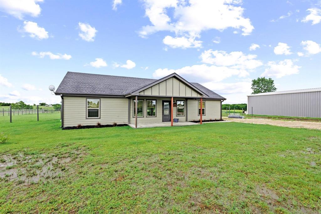 This home is ''like new'' and sits on 1.32 UNRESTRICTED acres of North Texas— no restrictions and no HOA! With a split open floor plan, this home has a spacious living area with a large kitchen featuring granite countertops, stainless steel appliances, corner walk-in pantry, trash can drawer, window above the sink overlooking the expansive backyard, large island with eating bar, and the stainless steel French door refrigerator conveys with the sale. ''Cramped'' is not a word in this home's vocabulary! The dedicated dining area is twice as wide allowing for additional space that could be used as an in-home office, pet area, or room for a huge table or additional built-ins. The primary suite is on the opposite wing from the secondary bedrooms with a walk-in closet, separate smaller closet, and en-suite primary bathroom with plenty of cabinet space and standing shower. Off the back porch, you have a massive backyard with views of trees and maintained countryside that is fenced with very nice livestock fencing that is higher than the standard backyard fence— bring your livestock friends! The dirt work is prepared for a shop slab right off the gravel driveway as well, not to forget the new landscaping and flagstone walkway off the covered front porch. There is so much to love about this rural property!