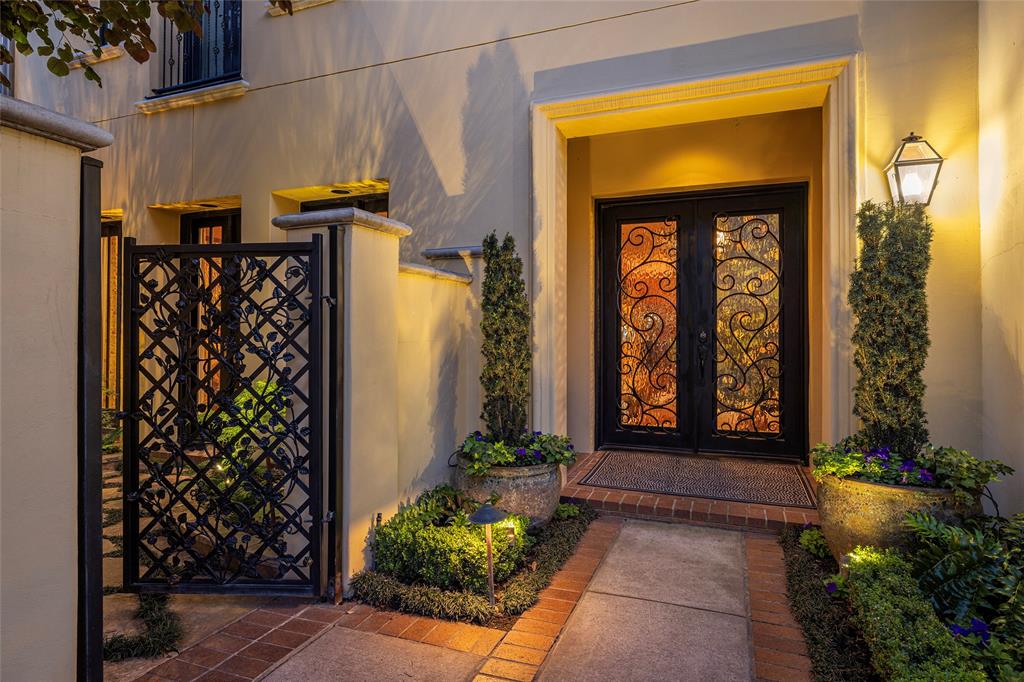 Bold Color.  Unique and gorgeous surfaces that you will not find nor see anywhere else.  Impeccable quality was demanded by this one owner townhome where equally impeccable care has been the utmost priority.  Exceptional landscape lighting and garden design create a visual that will be enjoyed and cherished year round.  You will love the custom designed garden gate. The interior invites spaces to share with family and friends.  Ten foot ceilings downstairs, nine foot up.  Solid core doors, 'His' and 'Hers' primary baths and closets, oak hardwood flooring.  Juliette balcony from the primary suite offers fresh air when the weather allows.  'His' bath includes Steam Shower.  Well-designed Wine Room fully utilizes the under the stairs.  The built-in storage space throughout this home is more than generous.  Rear Entry, alley access two car garage.
