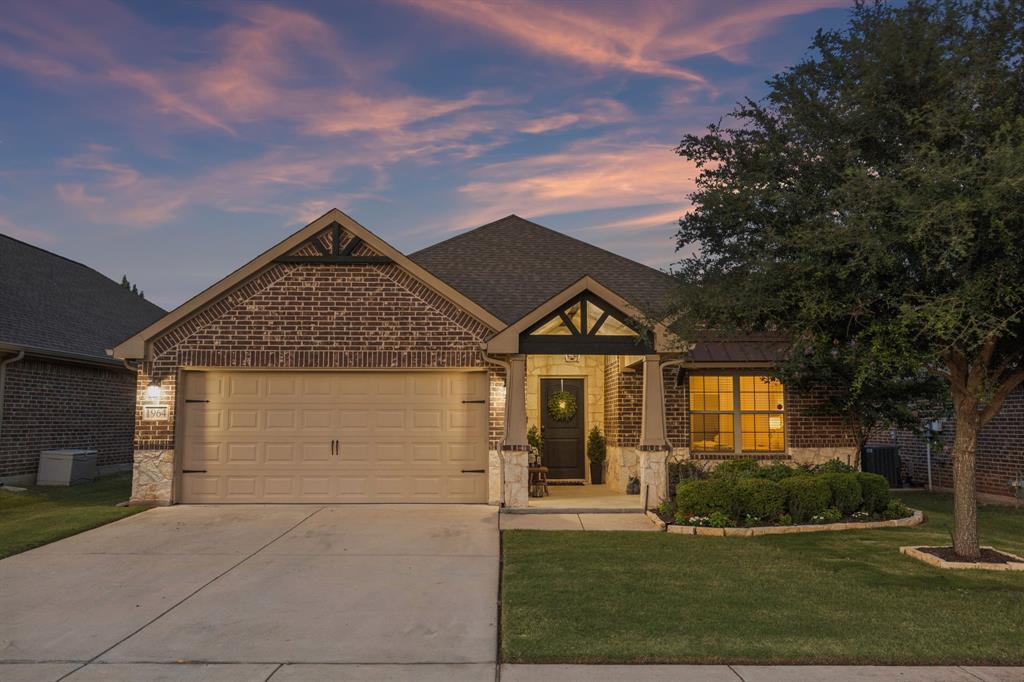 Move-in ready and loaded with upgrades, this beautifully maintained home is perfectly situated on a premium private lot backing to open green space offering exceptional privacy and peaceful views. Fresh interior paint creates a bright, clean feel throughout, while hardwood floors, rounded archways, designer subway tile, and a stunning wood barn door adds warmth and character. The open-concept floor plan is ideal for everyday living and entertaining, featuring an oversized granite island, stainless steel appliances including a gas range, and an upgraded stone gas fireplace that provides instant heat with the flip of a switch. A versatile flex room with a beautiful wood barn door offers the perfect space for a home office, playroom, or game room. The mud bench adds everyday convenience, and carpet is found only in the bedrooms for added comfort. Retreat to the spacious primary suite, where a wall of windows overlooks the expansive backyard and covered patio—creating a peaceful place to start and end your day. The oversized fenced backyard offers plenty of room to relax, entertain, or play. Additional upgrades include a conditioned, climate-controlled foam-encapsulated attic designed to stay within approximately 10 degrees of the home's interior temperature, helping improve energy efficiency, reduce attic heat, protect stored belongings, and create a more comfortable usable space year-round. Other features include a sprinkler system, full gutters, and window coverings. Located in the highly sought-after Eagle Mountain-Saginaw ISD, this home is just minutes from Eagle Mountain Lake, Alliance Town Center, shopping, dining, schools, medical facilities, major highways, the Fort Worth Stockyards, downtown Fort Worth, and approximately 25 minutes from DFW Airport. This is a home that truly must be seen in person to appreciate all it has to offer.