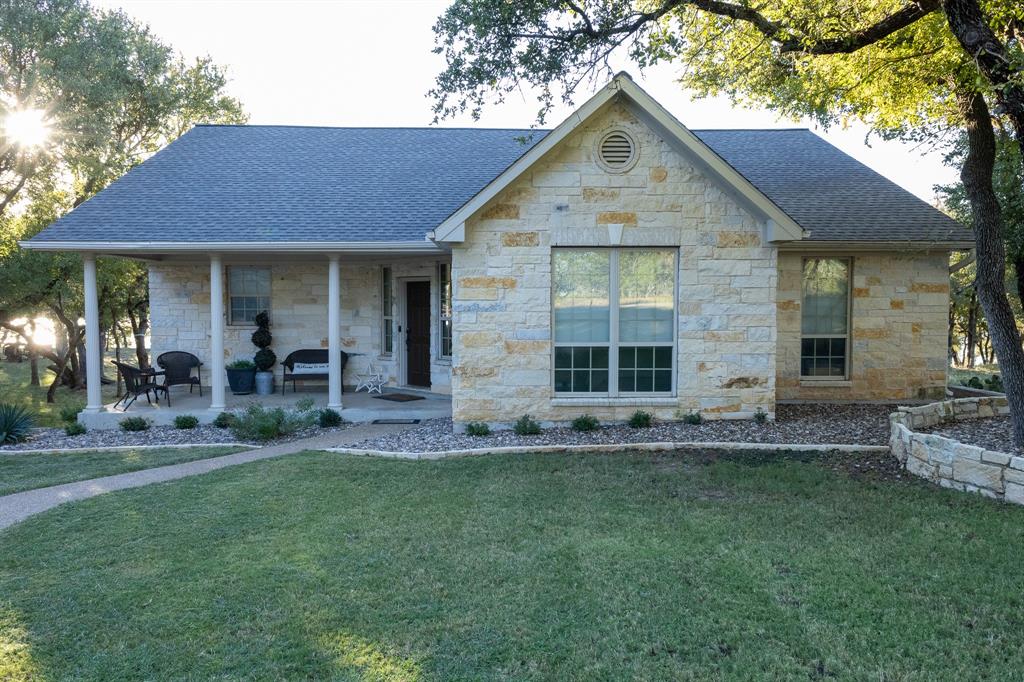 Lake Brownwood Waterfront Home with Deep Water, Private Dock & Guest Cabin

Exceptional waterfront living awaits at this Austin Stone home on Lake Brownwood. Offering 3 bedrooms, 2 baths, and 1,981 sq. ft., this property sits on deep water that, per the seller, has never been dry beneath the dock—a rare find on the lake.

The open-concept interior features vaulted ceilings, stained concrete floors, and large custom windows showcasing beautiful lake views. The kitchen offers custom cabinetry, pantry, island, eat-in bar, gas cooktop, refrigerator, microwave, wine cooler, and new granite countertops being installed in the kitchen and living areas.

The primary suite includes an ensuite bath with dual vanities, granite countertops, Jacuzzi tub, separate shower, water closet, and walk-in closet. Two guest bedrooms are arranged in a split-bedroom layout and share a second full bath with granite counters and a tub-shower combination.

Outdoor amenities include landscaped grounds, a fire pit, and a spacious deck overlooking the water. A matching detached two-car garage provides additional storage for vehicles or lake equipment.

The private dock is accessible by foot or vehicle and features a new 9,000-lb HydroHoist lift, swimming deck, and covered porches. Also included is an approximately 500 sq. ft. finished cabin on the dock with a living and sleeping area, kitchenette, bathroom, and TV—ideal for guests or additional lake living space.

A rare opportunity to own a deep-water Lake Brownwood property with exceptional outdoor and waterfront amenities.
