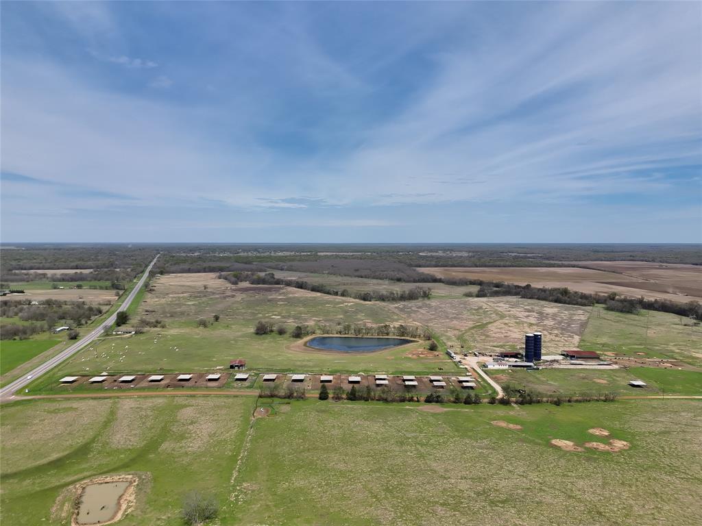 Located just four miles north of Mt. Vernon, this exceptional ranch presents a rare combination of agricultural productivity, recreational appeal, and long-term development upside. Positioned on a highly visible hard corner at Hwy 37 and County Road NE 2210, the property boasts nearly 5,000 feet of highway frontage and over 3,000 feet of county road access—offering unmatched accessibility and exposure.
Currently operating as a functional cattle operation, the property is well-equipped for continued livestock use or expansion. With over 20 feed pens, multiple grass turnout traps, and an efficient system of lanes, working pens, and load-out facilities, this ranch is ideally suited for a pre-conditioning yard, backgrounding operation, or heifer development program. Approximately 320 acres of improved pasture provide excellent grazing and forage production potential, while new fencing along Hwy 37 adds both value and security.
Beyond its agricultural strengths, the property offers outstanding recreational opportunities. Approximately 70 acres along Bear Pen Creek on the eastern boundary provide prime wildlife habitat, supporting whitetail deer, hogs, and other native species. The combination of water, cover, and nearby agricultural food sources creates an ideal setting for hunting and outdoor enjoyment.
The location further enhances the property’s appeal. Mt. Vernon’s revitalized downtown square has seen significant updates in recent years, bringing new restaurants, shops, and community activity that continue to drive growth in the area. With close proximity to I-30, the property is well-positioned for future residential, commercial, or mixed-use development as expansion continues east of the Dallas metroplex.
Additional improvements include a 1,600 sq ft, 2-bedroom, 2-bath brick home—perfect for an employee residence or rental opportunity. The seller also has an additional 100 acres of nearby pasture available for purchase, offering the potential to expand.