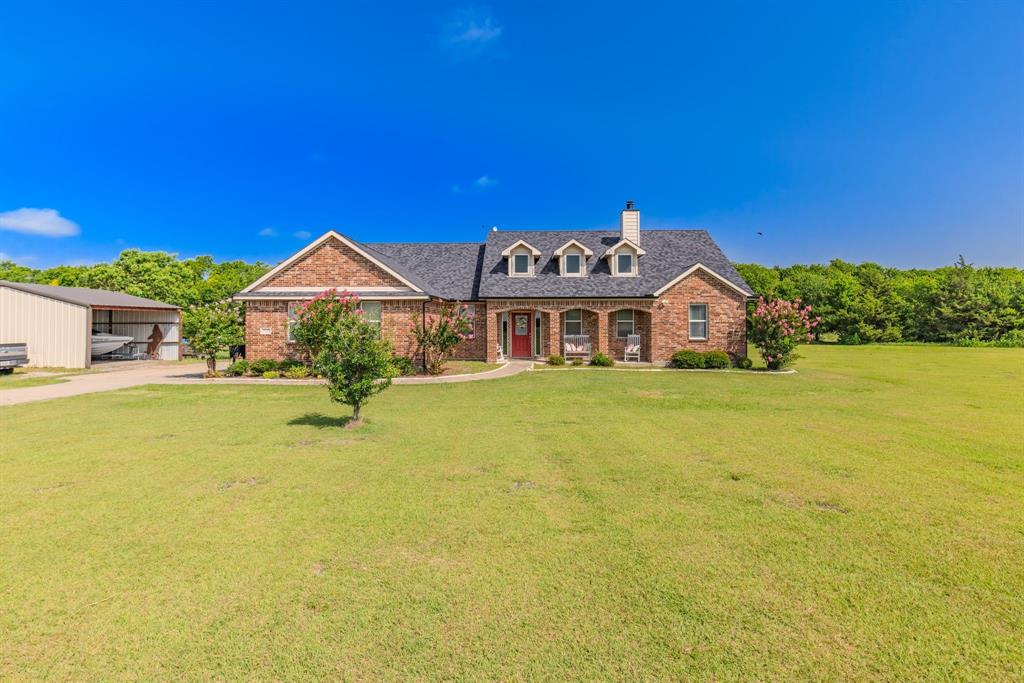 Nestled on just over 2 peaceful acres, this charming 3-bedroom, 2-bath home offers the perfect blend of country living and everyday convenience. This beautiful brick home features a functional floor plan with a dedicated office—ideal for working from home, a playroom, or hobby space. The partially open-concept kitchen flows into the spacious living area, creating a welcoming space for everyday life and entertaining. A dedicated laundry room adds convenience to your daily routine. Both the covered front porch and covered back patio provide the perfect spots to enjoy your morning coffee or unwind in the evenings. Step outside to a fenced backyard that backs up to a beautiful greenbelt, offering peaceful views and added privacy with no rear neighbors. The property also includes a covered carport structure, perfect for storing a boat, lawn equipment, tools, or additional outdoor gear. Conveniently located just off FM 3211, you'll enjoy an easy commute with direct access to Caddo Mills, Greenville, and Merit while still experiencing the tranquility of country living. If you've been looking for space to spread out, beautiful natural surroundings, and a house that just feels like home, this property is one you won't want to miss!
