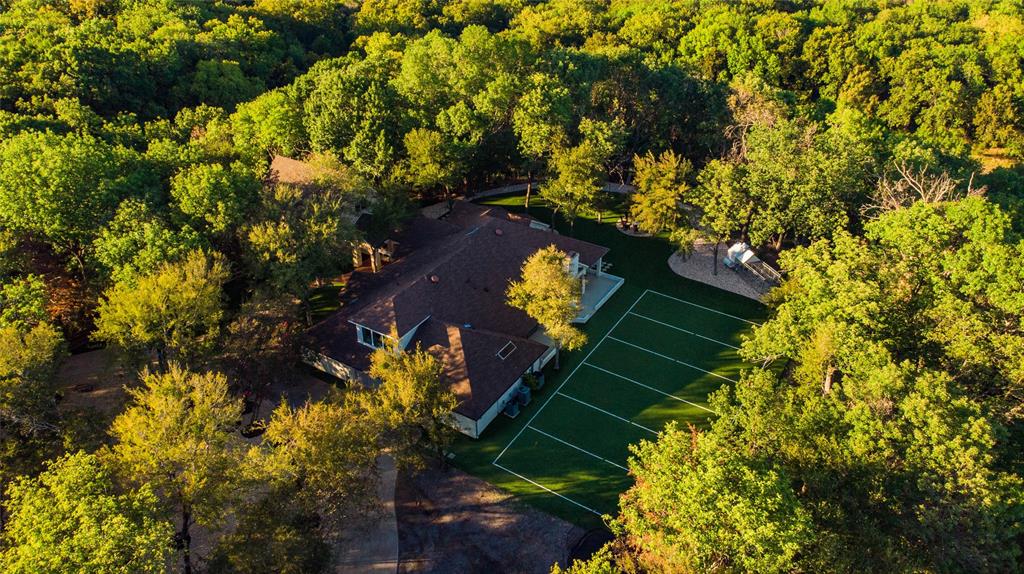 North Rockwall Private & Treed ACREAGE & a home the likes you have never seen. Tucked back behind the gated N Anna Cade & E Anna Cade sits this private & peaceful paradise. Bought and completed updated, added onto and remodeled, there is something for everyone. Over 7000SF of comfortable luxury that offers charm & appeal with the mind blowing updates of current style that blend together perfectly to create a true masterpiece. Offering nearly 22 acres, the home sits high upon a bluff and overlooks the beautiful towering treed acreage below. Property backs up to Camp Creek, has a pond & there are several open meadows that make this property perfect for cows, horses etc. (OH, & DEER TOO) Enter thru the gated entrance off of Anna Cade and wind your way back to your own private sanctuary. Property offers 5 bedrooms (2 Primary Retreats) Everything is one main level except one En-suite, a GameRoom & the basement which is perfect for a craft, exercise room etc. Don't miss the TURF FOOTBALL FIELD! The possibilities here are endless. These properties hardly ever come up for sale. Must see to truly appreciate the experience.