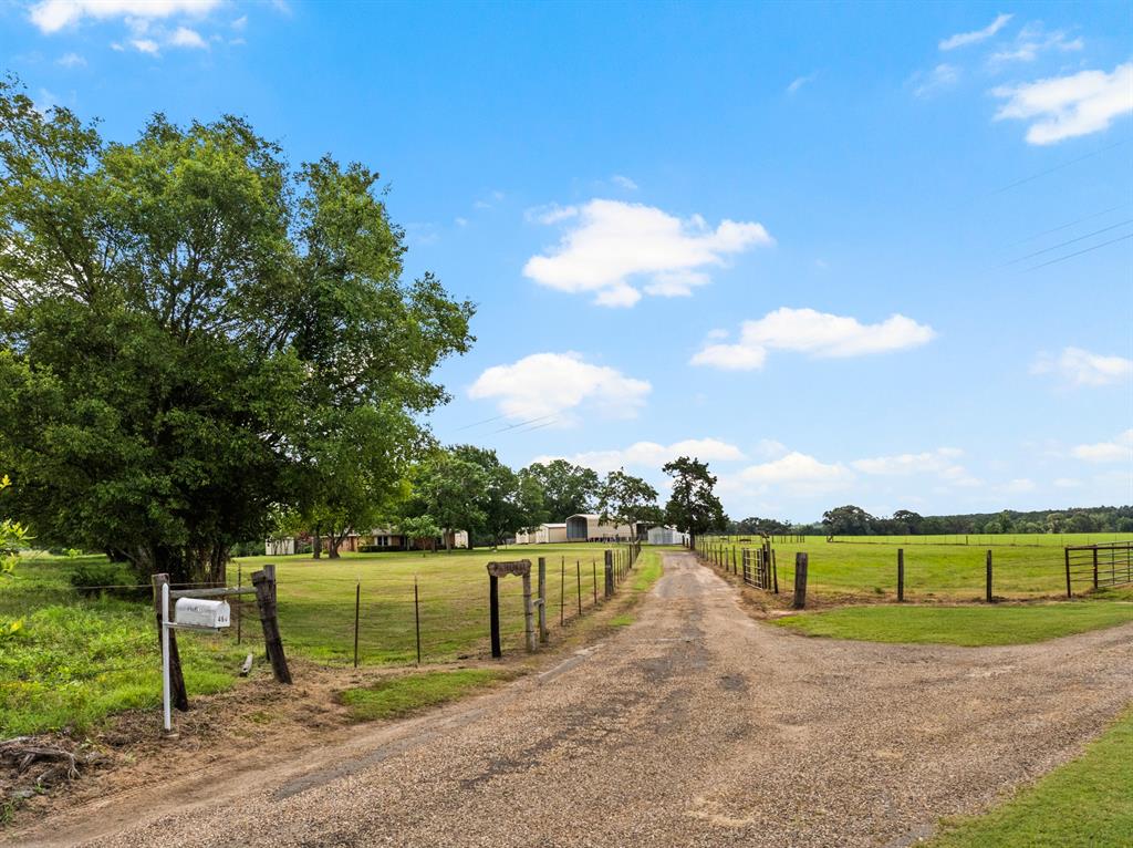 Searching for the move in ready immaculate home, this 1649 sq. ft. 3-bedroom two full baths is it. It sits on 16.23 acres that is cattle operation ready. The features that impact the value include 7 metal storage buildings, 4 have electricity. Two stall barn. Is on well water with a well house. Corral with loading Shutes. Covered 18 X 36 RV shed with electric hook up outlet. Pond has catfish and perch. Covered 24 x 24 carport on concrete slab. Partial concrete driveway. Three pecan trees. New Panel box in 2025 set up to accommodate a whole house generator. Property is completely fenced with pasture area separately fenced to keep your cattle contained and grazing contently on this lush pastureland. Property has security gate and is located on a private dead-end road. Minutes to the grocery store. Seclusion and Peace is an understatement. This property is pristine and beautifully manicured. Get your boots on Ya'll and come see what this is all about.