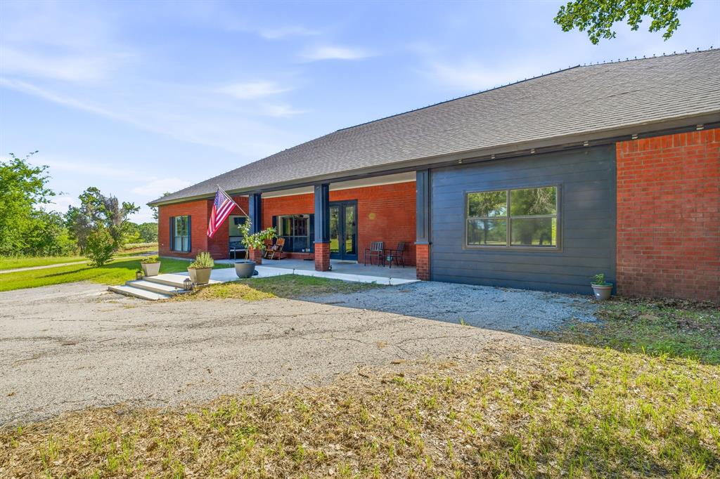 Escape to your own private Texas retreat on 39+ fully fenced acres, conveniently located and accessed by a paved driveway lined with beautiful mature trees.  At the heart of the property sits a spacious 2,822 sf 3 bed, 2.5 bath brick home featuring an open-concept design and a desirable split-bedroom floor plan. The open-concept living room, dining area, and kitchen create the perfect gathering space for family and friends. A large kitchen island and beautiful wood-burning fireplace serve as focal points, making this area truly the heart of the home.  The home's comfortable layout is ideal for both everyday living and entertaining, with large windows to showcase the surrounding natural beauty.  Step outside to the back patio and enjoy peaceful views of one of two ponds, including a spring-fed pond that maintains water year-round. The property's amazing landscape and abundant wildlife, create a truly serene setting for outdoor enthusiasts and nature lovers alike. Adding even more versatility and value is a 2,625-square-foot guest quarters and shop combination. Thoughtfully designed, the guest living space includes one bedroom, one bathroom, a full kitchen, washer and dryer, with modern finishes throughout. The attached shop offers one insulated bay and one uninsulated bay with a roll-up door, making it ideal for equipment storage, or hobbies.  One of the property's most remarkable features is its sustainable water system. Two natural springs supply water to both homes, supplemented by a reverse osmosis filtration system and a rainwater collection system, providing clean, reliable, and efficient water sources rarely found on properties of this caliber.  Whether you're seeking a full-time residence, recreational ranch, multi-generational living arrangement, or weekend getaway, this exceptional property offers the perfect blend of comfort, functionality, water features, wildlife, and natural beauty.