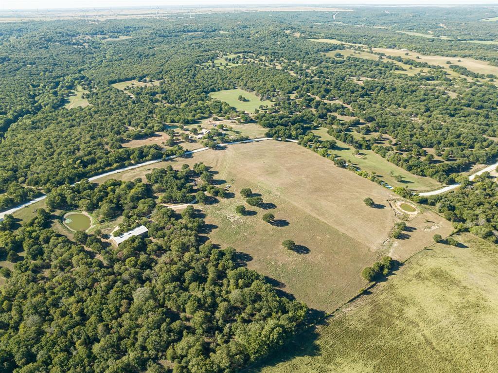 If you're looking for peace, tranquility, gorgeous views, and an opportunity to create a lifetime of memories this is the perfect place for you.  This picturesque 38.99 acres property provides expansive views and varied topography, vegetation & habitat for wildlife including whitetail deer, wild turkey, and dove.  A diverse combination of pasture and wooded areas offers options for hunting, recreation, or livestock grazing.  This sprawling acreage with its 2 bed, 2 bath (1419 sq ft) barndo and 40'x60' attached insulated workshop lends itself to endless possibilities.  Level land perched at a prime height point is a perfect spot for a future home. Electric gate, well, septic, electric, 2 ponds, corral with crowding gates and fresh water trough. Ostrich Winery and 4R Ranch Vineyards & Winery just minutes away.  1 hour from Ardmore OK and 1.5 hours from Fort Worth makes this the perfect weekend getaway. This property is a MUST SEE!
