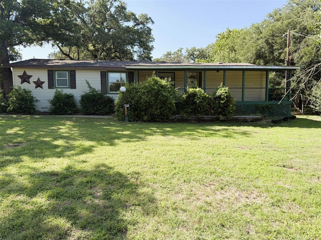 HUD case number 513-173533.  SOLD AS IS with all faults.  Enjoy country living within the Lake Granbury community.  This 3-bedroom 2-bath double-wide mobile home sits on a 6-lot one acre property within the Sky Harbour subdivision offering fantastic amenities including boat ramp, fishing pier, park with playground, community pool and planned community events.  Open floorplan includes 2 living areas, dining area and kitchen with tons of storage.  Primary suite boasts of a huge walk-in closet and ensuite bath with dual vanities and a beautiful, extended walk-in shower with dual showerheads.  2 auxiliary bedrooms, one with walk-in closet, are perfect hideaways for a teen, younger child or guests.  Separate utility room offers full size washer-dryer area, storage cabinets, shelves and outside entrance from the back patio creating mudroom function.  Enjoy cool evenings on your covered porch or patio, or entertain family and friends with a cookout and volleyball.  Need a place to store recreation vehicles or a boat?  2 carports provide 6 parking spots.  Added bonuses:  The tiny house with electricity could make a wonderful private retreat or child's playhouse.  And, the workshop with electricity could be the perfect mechanics haven or woodworking shop.  Come take a look at the possibilities!