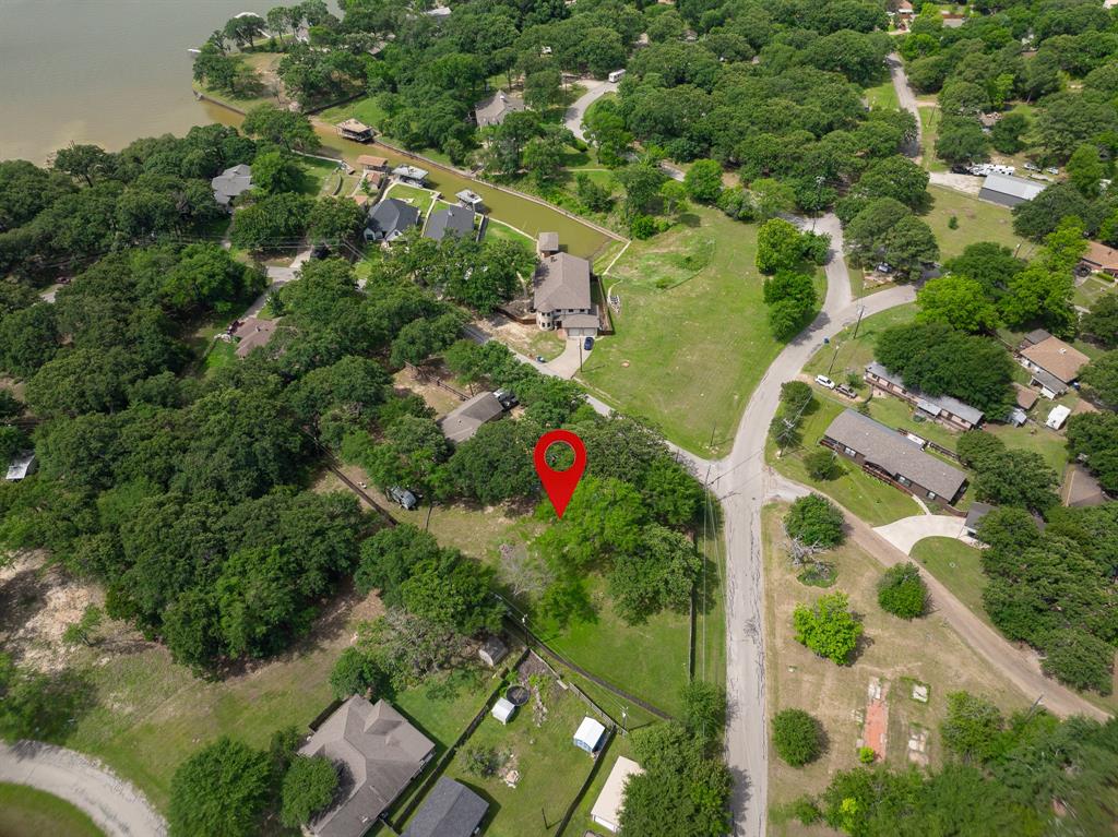 Build your Cedar Creek lake-area retreat on this water-facing vacant lot just two blocks from the cove. Located on Autumn Wood Trail in the established Mantle Manors subdivision, this approximately 0.241-acre homesite offers a desirable setting for a full-time residence, weekend getaway, or investment build. Tucked into a lake-area neighborhood with surrounding established homes, the lot offers an appealing opportunity for buyers who want to create something of their own near the water. Enjoy the relaxed pace of Cedar Creek living with convenient proximity to boating, marinas, fishing, waterfront dining, shopping, and everyday conveniences in Gun Barrel City. Whether the vision is a quiet weekend escape, a low-maintenance lake-area home base, or a future build-and-hold investment, this parcel offers a practical and well-positioned entry point into the Cedar Creek market. Buyer to independently verify building requirements, deed restrictions, minimum square footage, setbacks, utility availability, zoning, and development feasibility.