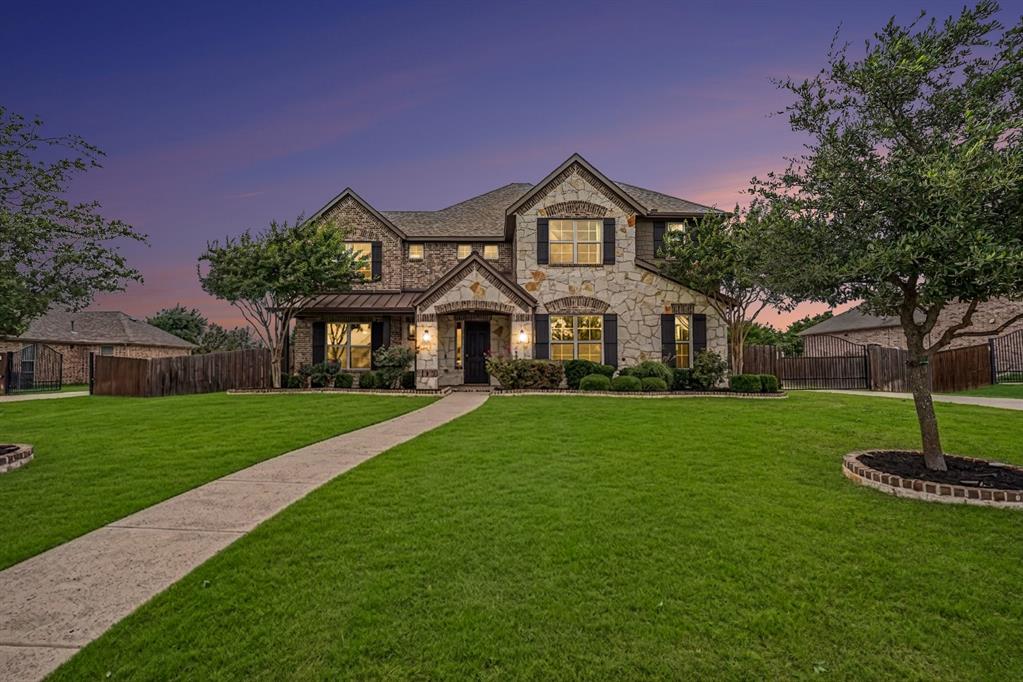 Exceptional 5 BR, 4.5 BA estate on a beautifully landscaped 0.43 acre lot with 4 Car GA, Separate Study & Media Room in the popular Stoney Creek community & Sunnyvale ISD.  Designed for those who value space to live, play, & grow, this meticulously maintained home offers an incredible backyard retreat, gated privacy, & access to outstanding neighborhood amenities, just minutes from Lake Ray Hubbard.  An automatic gated entry & elegant new fencing create a private sanctuary, while the oversized gated driveway & garage provide ample space for vehicles, sports equipment, & guests. The expansive lot offers endless possibilities for outdoor living, recreation, & entertaining, with plenty of room for backyard games, future enhancements, & family gatherings. Inside, wood floors, abundant natural light, & an open-concept layout create a warm and welcoming atmosphere. The chef’s kitchen is equipped with granite countertops, premium cabinetry, under-cabinet lighting, a coffee bar, double ovens, gas cooktop, & top-of-the-line KitchenAid appliances, making it the heart of the home for everyday living & special occasions. The spacious family room overlooks the backyard oasis with private views & seamlessly connects to outdoor entertaining spaces, including a side patio w gas grill connections & a separate pet-friendly yard. The thoughtfully designed floor plan is ideal for families of all sizes, featuring a luxurious 1st floor, primary suite, private office, expansive game room, dedicated media room w theater seating, & ensuite baths with custom closets for every bedroom. Beyond the property, Stoney Creek delivers an exceptional lifestyle with community fishing ponds, swimming pools, playgrounds, walking trails, parks, & sport courts, creating endless opportunities for outdoor fun & neighborhood connection.  Located in a quiet, well-maintained community known for its large lots, this move-in-ready estate offers the rare combination of luxury, privacy, recreation, & community.