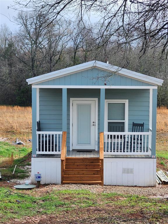 Escape to the best bass fishing in Texas! This beautiful tiny home has everything you need for your personal get away. Located in a community on Lake Fork, enjoy the neighborhood boat ramp, multiple pools, playground, and restaurant without leaving the neighborhood. Enjoy both front and back porches where you can sip your coffee or cocktail and soak in the relaxation. There is nothing behind this house providing a serene view. The fully furnished house comes with a queen bed, sleeper sofa, washer and dryer combo and everything you need for a lake house. Lake Fork is a world-famous fishing lake hosting numerous tournaments a year. Just two hours from the Metroplex and 45 minutes to Canton Trade Days. Whether for full time living or part time escape, this home is quaint and inviting!