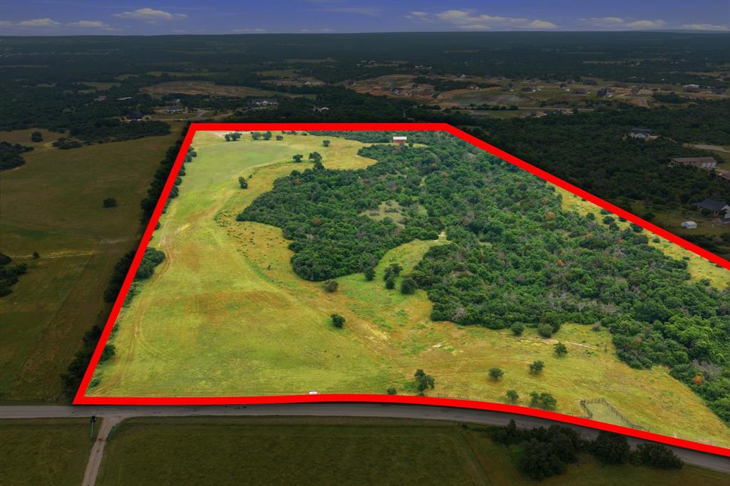 This stunning 54-acre property offers gently rolling terrain accented by an abundance of mature trees and sweeping countryside views in every direction. Located outside the city limits, the land provides a peaceful, private setting with endless possibilities for future development, investment, or a secluded custom estate. Whether envisioned as a private ranch retreat or a long-term development opportunity, this property combines natural beauty, space, and flexibility in a truly exceptional setting.