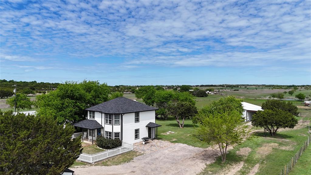 Renovated 3 bedroom, 2 bath home on just over 5 acres on the Fort Worth side of Granbury. This fenced and cross-fenced property offers a great setup for country living with a gated entry, wraparound porch, and a shop with two stalls. The home has been updated and is move-in ready, while the acreage provides room for livestock, hobbies, or simply enjoying the extra space. Convenient location for those needing easier access toward Fort Worth while still enjoying the privacy and functionality of a small acreage property.