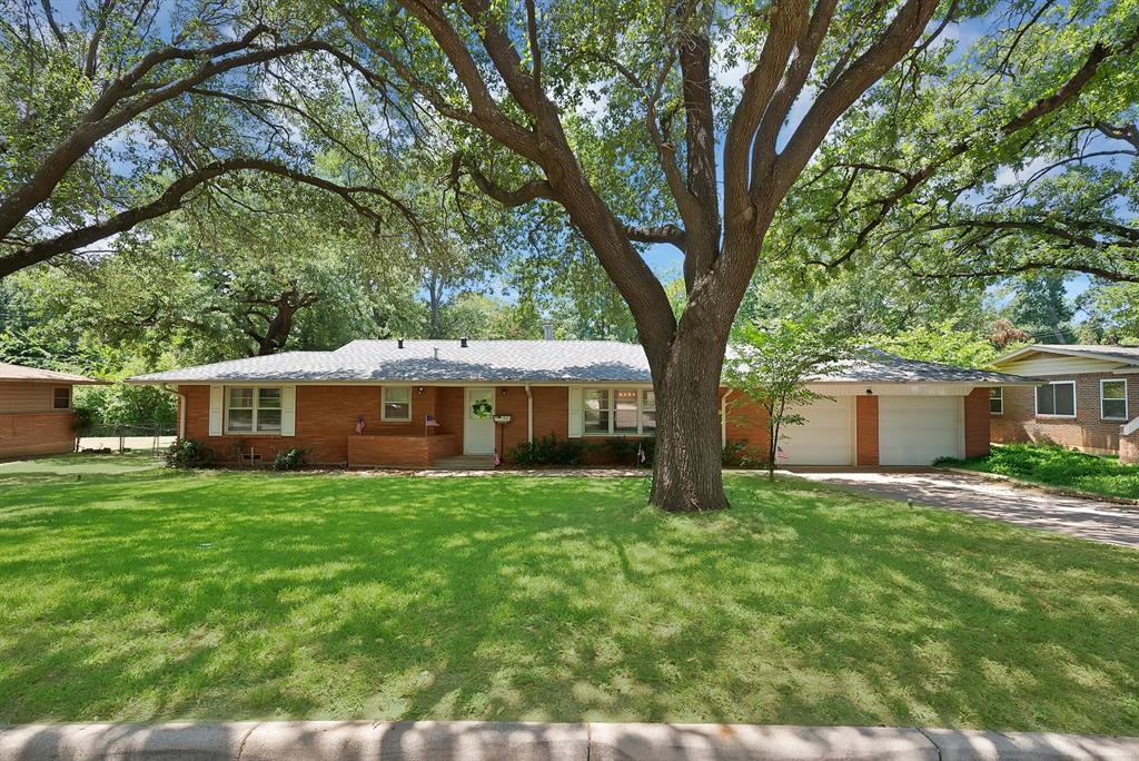 Located in the heart of the highly sought-after 013, this beautifully updated home perfectly blends the charm of an established, tree-lined neighborhood with the modern finishes today's buyers love.

The open-concept kitchen is the heart of the home, featuring a large quartz island, updated cabinetry, designer backsplash, stainless steel appliances, and a custom coffee bar that's perfect for everyday living and entertaining.

Original hardwood floors run throughout, adding timeless character, while thoughtful updates create a fresh, move-in-ready feel.

Step outside to enjoy spacious front and back yards with lush grass, a covered patio ideal for relaxing or hosting friends, a storage building that doubles as a charming playhouse, and a convenient drive-through garage with easy backyard access.

Even better, the washer, dryer, and refrigerator are all included, making this home truly move-in ready.