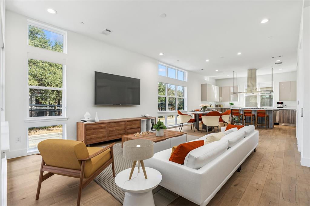 This modern corner unit at 3081 Chimes Street offers 2,871 square feet of thoughtfully designed living with 4 bedrooms, 4.5 bathrooms, a private two car garage, and a fenced front yard in one of Dallas’s most desirable locations. As a coveted corner unit, the home features additional windows throughout, creating a bright and open feel across all levels, while hardwood floors complement the seamless multi level floor plan ideal for both entertaining and everyday living. The layout includes two spacious living areas and an elevator with access to all four stories, along with window shades throughout for added comfort and privacy. The kitchen anchors the main living level with stainless steel appliances, a gas cooktop island, built in wine refrigerator, and custom cabinetry. Bedrooms are generously sized with abundant walk in closet space. Outdoor living is highlighted by a second floor covered patio and a fourth floor rooftop terrace with expansive downtown skyline views, offering an exceptional setting for relaxing and entertaining.