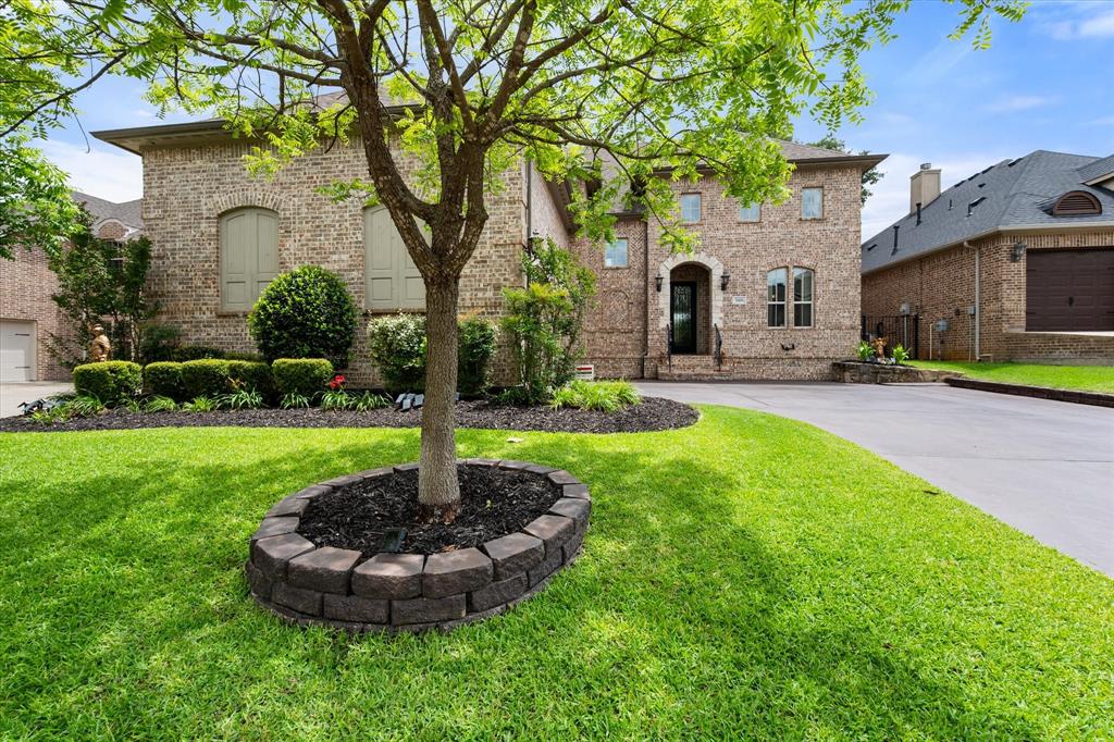 Luxury, comfort & exceptional attention to detail define this meticulously maintained Graham Hart home situated on a quiet cul-de-sac in the highly sought-after Martin High School district. This stunning residence offers an exceptional floorplan, beautiful finishes and numerous recent updates. A striking iron and glass front door welcomes you into a grand entry featuring rich hardwoods that extend throughout most of the main level. The thoughtfully designed floorplan includes the primary suite & a secondary bedroom on the first floor providing flexibility for guests or a home office. The open-concept family room flows seamlessly into the chef's kitchen which is anchored by a massive center island & showcases beautiful Taj Mahal quartzite countertops, double ovens, a custom wood canopy vent hood and abundant cabinetry. Recent kitchen updates include a Bosch DW (2025), garbage disposal (2024) & microwave (2021). The primary suite offers a relaxing retreat with recently replaced carpet and a luxurious bath featuring Taj Mahal quartzite-topped vanities. Upstairs, you'll find a spacious game room, a dedicated media room, 3 additional bedrooms and 2 full baths. The game room includes a pool table with a convertible ping-pong tabletop that conveys with the home. Additional upgrades include custom window valances, plantation shutters, glass sliding tub enclosures in all 3 secondary bathrooms & a downstairs HVAC system replaced in October 2025. The oversized garage is enhanced with built-in storage closets and cabinetry. Step outside to enjoy the large backyard and expansive covered patio, ideal for outdoor living and entertaining. Beautiful Chinese Pistachio trees enhance both the front and back yards, while a tranquil fountain creates a peaceful outdoor retreat and will remain with the property. Combining timeless design, quality craftsmanship, thoughtful updates, this exceptional home offers a rare opportunity in one of Southwest Arlington's most desirable neighborhoods.