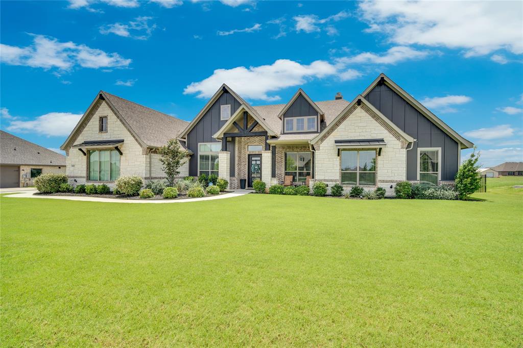 Welcome to 9236 Dove Hollow Road, a stunning 2023 Modern Farmhouse nestled on over one acre in the sought-after Paloma Ranch community of Justin, Texas. From the moment you pull up to the gorgeous stone and board-and-batten exterior, this home commands attention with dramatic rooflines, mature landscaping, and a wide sweeping lawn that sets the tone for everything inside.

With 5 bedrooms, 4 bathrooms, and over 3,700 square feet of thoughtfully designed living space, this home delivers the perfect balance of luxury and livability. The primary suite is a true retreat, featuring a spacious tray ceiling, and a wall of windows that floods the room with natural light. The spa-worthy primary bath offers dual vanities with warm wood cabinetry, gold-framed mirrors, statement lighting, a freestanding soaking tub, and a separate glass-enclosed shower with herringbone tile, all leading directly to the walk-in closet.

Secondary bathrooms are equally well-appointed, with designer tile, framed mirrors, and custom touches throughout. The fenced one-acre lot offers endless possibilities for a future pool, workshop, or outdoor entertainment space, while the gated side entry adds both security and curb appeal.

Located in the highly rated Northwest ISD and just minutes from Alliance Town Center, Texas Motor Speedway, Champions Circle Golf Club and Resort, Big Shots Golf, and major highways including 35W, 114, and 170 for easy access to DFW Airport, Downtown Fort Worth, and Southlake Town Square. A rare opportunity to own a move-in-ready luxury home with room to grow.