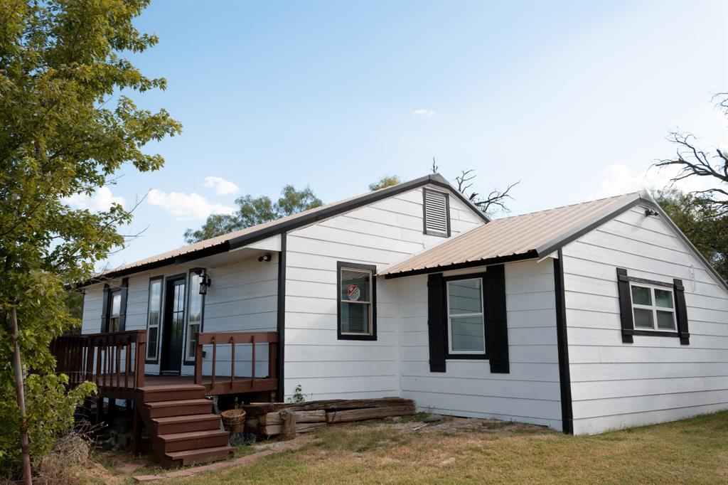 ATTENTION INVESTORS!  Achieve instant income with this property as the current tenant has a lease until 3-1-27.  After that you can continue leasing or begin enjoying a quiet neighborhood and views of the lake from the spacious deck on the front of this completely refurbished 3 BR 2 Bath home.   Everything is new including the central heat and air unit, plumbing, electrical, flooring, counters and more.   The metal roof is in great shape so was not replaced.  The main bedroom and ensuite are a garage conversion and feature two closets, double sinks and a jetted soaker tub.  The kitchen opens up into the living and dining area separated by a breakfast bar.  This home is bright and cheery with lots of natural light.  There is plenty of room to spread out on almost half an acre which features mature trees and a storage building.  The landscaping possibilities are endless to make it your own.  Seller is planning to install an electric gate in the decorative metal fence in the front for added privacy.  Come and take a look at this little gem!