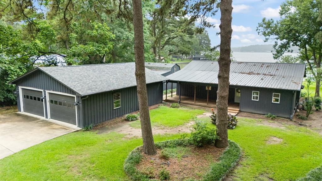 The perfect lake house on Lake Cypress Springs! This is the opportunity buyers have been waiting for! A property offering million dollar views at a price point rarely found on the lake. Situated on an incredible waterfront lot with expansive open water views, this property combines breathtaking scenery, recent updates, and exceptional versatility. The property features a 1,652 SF main home, a 640 SF guest house, and an oversized shop, providing plenty of space for family, friends, and all your lake toys. The recently updated main home offers 3 bedrooms and 2.5 bathrooms with an open concept design that is ideal for entertaining. Large windows capture the spectacular lake views, while the spacious living, dining, and kitchen areas create the perfect gathering space. The kitchen features stainless steel appliances and ample room for a large island. An oversized utility room provides additional storage and functionality. The primary suite offers a private retreat with an en-suite bathroom and walk in closet, while two additional guest bedrooms provide comfortable accommodations for family and visitors. The guest house includes a bedroom and full bathroom, making it ideal for overflow guests or extended stays. The oversized shop easily accommodates multiple boats, vehicles, golf carts, and lake equipment. Outside, the waterfront lot is truly the star of the show, offering some of the most impressive views on Lake Cypress Springs and the perfect location to build your dream boathouse. Located in a highly desirable gated subdivision, residents enjoy outstanding amenities including a boat ramp, community pool, tennis courts, and more. Whether you're looking for a weekend getaway or a full time residence, this property delivers everything buyers love about lake living.