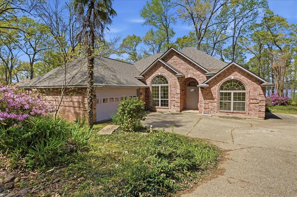 Welcome to your private retreat on beautiful Lake Palestine, where comfort, craftsmanship, and nature come together in perfect harmony. This one-owner, custom-built 3 bedroom, 2 bath home is nestled within a gated, well-established community, offering both security and a true sense of tranquility.
From the moment you arrive, you’ll be captivated by the meticulously designed custom landscaping that enhances the home’s curb appeal and blends seamlessly with the natural surroundings. Step inside to discover a thoughtfully designed layout with spectacular lake views that maximizes both functionality and comfort, perfect for full-time living or a weekend escape.
Out back, the property truly shines. Enjoy peaceful mornings and breathtaking sunsets with stunning lake views, while an abundance of wildlife creates a serene, ever-changing backdrop. The private two-boat dock, complete with lifts, makes lake living effortless—whether you're heading out for a day on the water or simply relaxing by the shoreline.
This is more than just a home—it’s a lifestyle. Whether you're entertaining guests, enjoying quiet evenings by the water, or taking advantage of everything Lake Palestine has to offer, this property delivers a rare opportunity to own a slice of East Texas paradise.