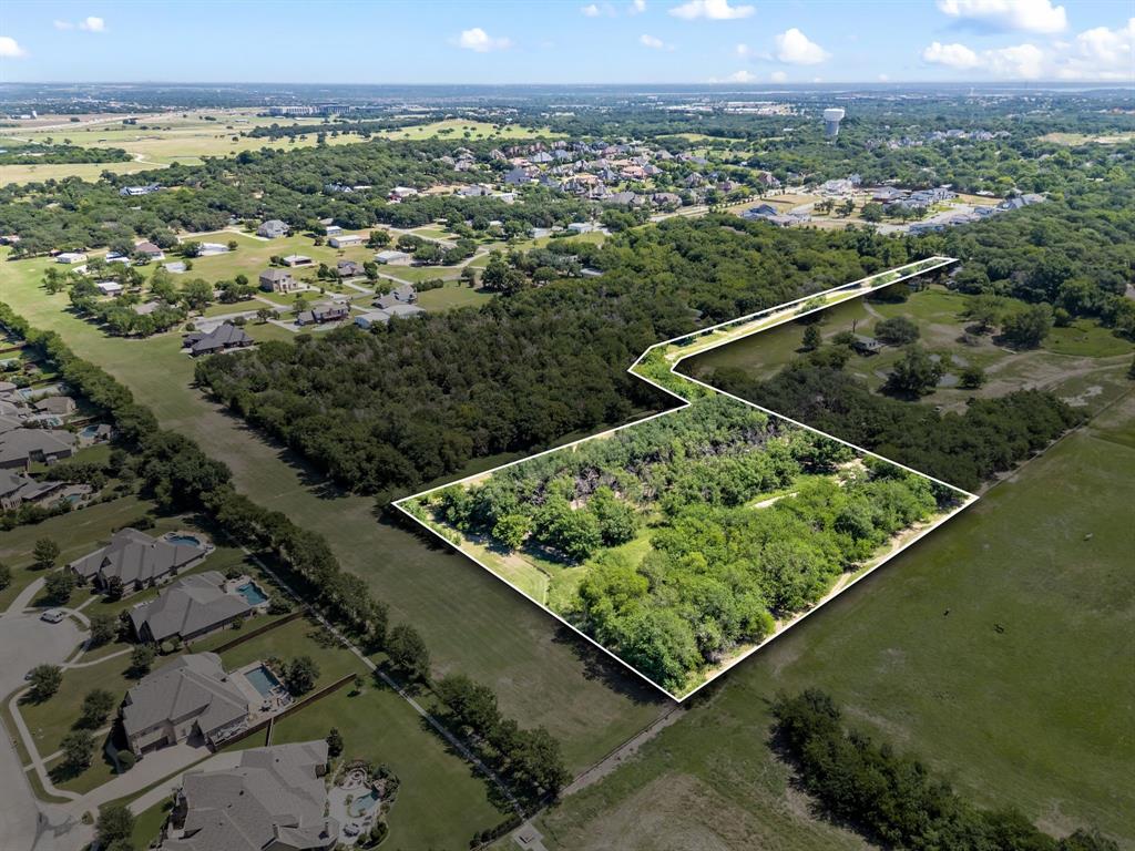 A rare and remarkable opportunity to own over 5 pristine acres in the coveted town of Westlake, Texas. This expansive homesite offers an unparalleled canvas to build your dream estate, family compound, equestrian retreat, or private sanctuary. Surrounded by lush native landscape and mature trees, the property provides a serene and secluded setting while still offering exceptional access to the best of DFW.
Located just minutes from the prestigious Vaquero Club—a private, world-class golf and lifestyle community—and only a short drive to Southlake Town Square, this location combines luxury living with everyday convenience. Residents have the unique option to choose between two of the area’s most highly acclaimed school systems: the award-winning Carroll ISD or the internationally recognized Westlake Academy, an IB World School.

Whether you're seeking tranquility, prestige, or proximity to top-tier amenities, this property delivers on all fronts. Enjoy the freedom to design a one-of-a-kind estate with ample space for a resort-style pool, tennis or pickleball courts, guest quarters, gardens, —all without the constraints of an HOA.

Tucked away in one of North Texas' most desirable enclaves, yet offering quick access to major highways, DFW International Airport, shopping, dining, and entertainment, this extraordinary parcel represents the perfect blend of privacy, elegance, and location. An exceptional investment in lifestyle and legacy—bring your architect, your dreams, and your vision to life on this premier piece of Westlake land.