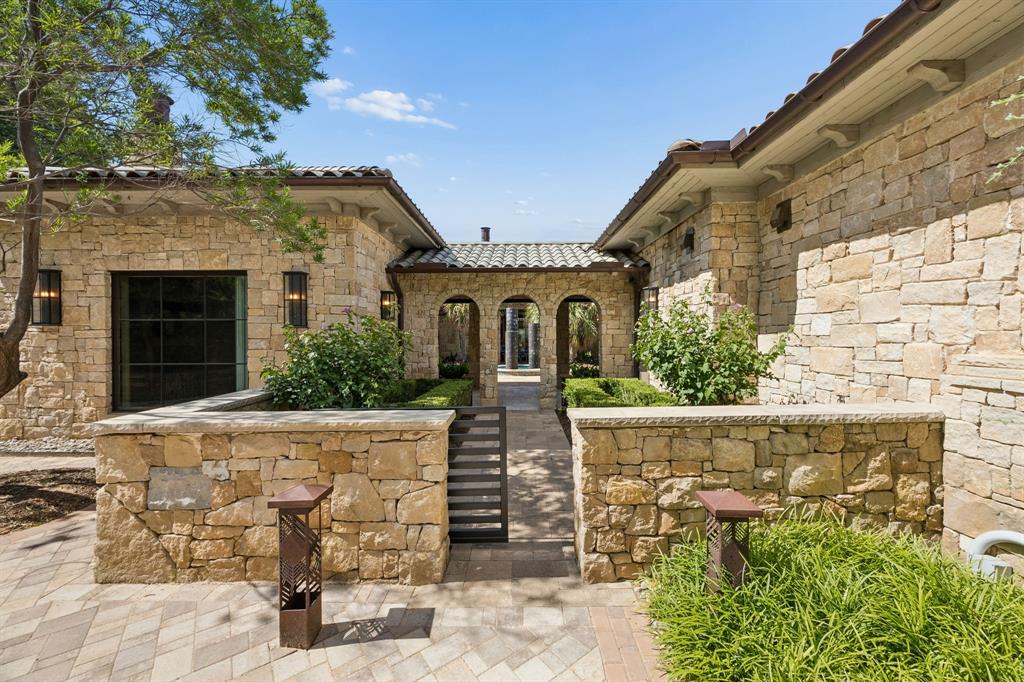 Location. Luxury. Lifestyle! Vaquero, Westlake's most exclusive guard-gated enclave, is proud to present 2006 Nighthawk Court — a resort style home  seamlessly blends breathtaking interior craftsmanship with an outdoor living experience unlike any other. Thoughtfully designed with an open floor plan, this 4-bedroom, 4 full and 2 half bath masterpiece showcases white oak wood floors, designer lighting, La Cantina doors, natural stone, and curated finishes throughout.The chef's kitchen is the heart of the home, featuring a Thermador 6-burner gas cooktop with griddle, Thermador refrigerator, built-in coffee machine, sonic ice maker, custom mosaic tile backsplash, and a stunning quartzite waterfall island. The primary suite showcases outdoor living and a spa-inspired bath with marble counters, a grand glass walk-in shower with a Hollywood soaking tub nestled inside. Three custom walk-in closets complete the retreat, one of which is appointed with a washer and dryer. The media room is pre-wired for surround sound and features designer wallpaper and media lighting. A private study with custom built-ins, quartzite countertops, and a built-in sink rounds out the interior — along with three living areas and more exceptional spaces to discover. A two-story casita with a full guest suite, powder bath, appointed kitchen, and covered patio adds extraordinary versatility. Outdoors, a covered living area with a Lynx grill, Lynx pizza oven, Evo cooktop, Coyote Cooker, SubZero beverage refrigerator, gas fireplace, and pergola sets the stage for effortless entertaining, while a sparkling pool and spa complete this resort-inspired backyard. A three-car garage — one climate-controlled with a glass door — completes this remarkable masterpiece!  Westlake Academy, Keller ISD, or residents may also apply to Southlake Carroll ISD under Open Enrollment.