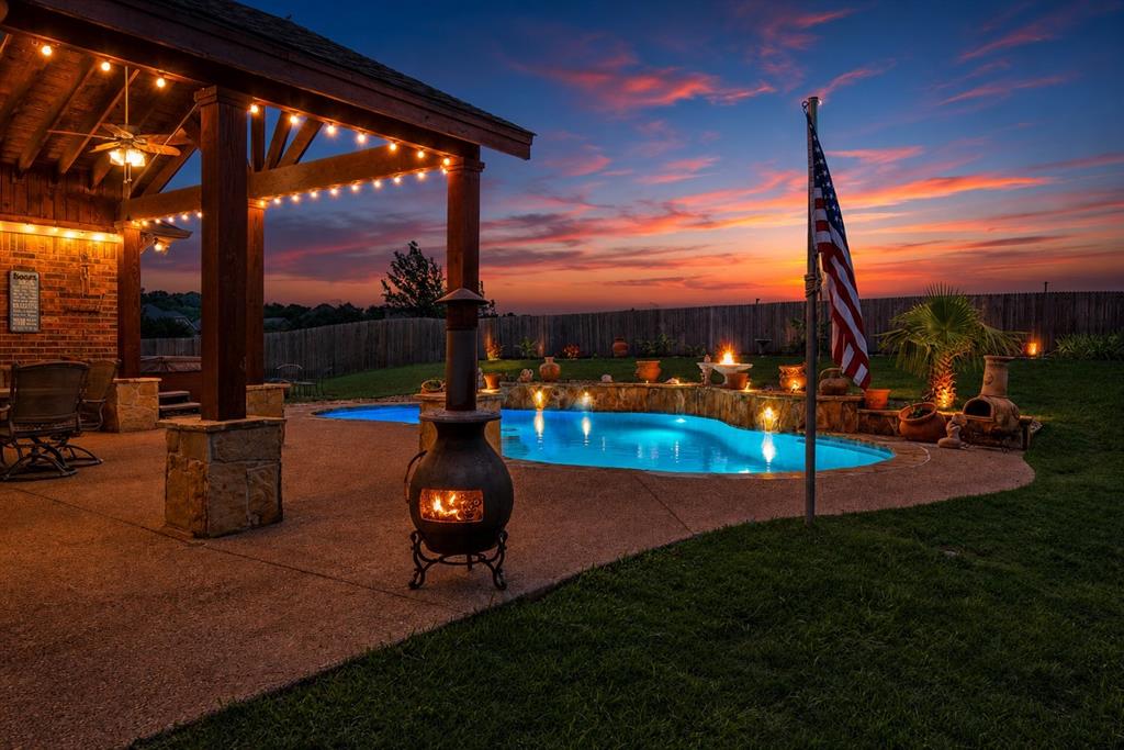 Welcome to this beautifully updated home in the sought-after Kingsridge community, where spacious design, timeless details, and resort-style outdoor living come together seamlessly. From the moment you step inside, you’re greeted by soaring ceilings, grand staircase details, rich natural woodwork, and an open-concept layout designed for both everyday comfort and effortless entertaining.

The heart of the home features an expansive living area open to the kitchen with granite countertops, oversized island seating, decorative lighting, abundant cabinetry, and seamless sightlines throughout the main level. Upstairs offers incredible flexibility with a large game room, dedicated media room, spacious secondary bedrooms, and room for everyone to spread out comfortably.

Step outside to your private backyard retreat featuring a resurfaced Pulliam pool completed in 2025, relaxing hot tub, covered patio, fire pit area, and plenty of green space on an oversized quarter-acre lot backing near greenbelt space for added privacy and tranquility. NO neighbor behind the house! 

Major upgrades provide peace of mind, including a NEW ROOF in 2024, updated electric panel and wiring in 2019, resurfaced pool with upgraded cleaner pump and freeze protection thermostat in 2025, patio addition in 2021, garage storage and opener in 2025, and permitted side storage shed attachment. Additional features include whole-home intercom and sound system wiring, hardwood flooring, decorative finishes, walk-in closets, 3-car garage, and Keller ISD schools.

This home offers the perfect blend of functionality, warmth, entertaining space, and thoughtful upgrades in an established neighborhood with parks, sidewalks, and greenbelt amenities nearby.