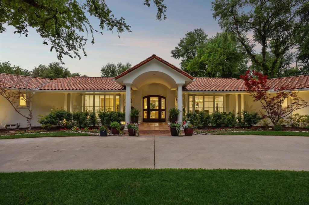 Set on nearly an acre in prestigious Old Preston Hllw, exceptional Santa Barbara-inspired estate blends timeless architecture w sophisticated modern living through thoughtfully reimagined single-level flr plan. Extensively remodeled & expanded in 2021–2023 under direction of acclaimed Anna Clark Interiors, home showcases refined design, luxurious finishes, & effortless indr-outdr living. Private primary suite addition & kitchen renovation elevate residence, offering 4 bedrms, 4 full baths, formal & informal living spaces, study, media rm, & guest quarters. Flooded w natural light & appointed w rich hardwd flrs throughout, home welcomes guests through gracious entry highlighted by striking chevron-patterned flring. Elegant formal dining flows seamlessly into living spaces designed for everyday comfort & entertaining. Remodeled gourmet kitchen feat large island w bar seating, Sub-Zero refrigeration, Viking 8-burner gas range w pot filler, Miele dishwasher, Blanco farmhouse sink, & bfast area framed by Andersen sliding drs overlking resort-style backyard. Adjacent living areas include wet bar, inviting family rm w gas FP, & expansive game rm w custom built-ins & walls of windows. Completed in 2023, oversized primary suite offers serene sitting area, dual walk-in closets, & spa-inspired bath w dual vanities, standalone tub, & oversized rainfall shower. 3 additional secondary bedrms w walk-in closets are complemented by 3 updated baths. Study w custom built-ins provides ideal work-from-home environment. Above 3-car garage, separate guest quarters, currently utilized as fitness studio, offer flexibility for guests, gym, or additional living space. Backyard feat extensive landscaping, turf, pool & spa, putting green, & oversized patio w covered loggia. Outdr living area includes gas FP, built-in grill, & bev refrigerator. Add'l highlights include classic stucco exterior, clay tile roof, epoxy garage flring, updated utility rm, & designer finishes throughout.