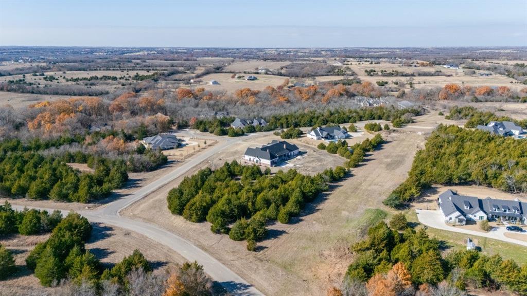 Welcome to the exclusive - Cliffs at Cedar Ridge! This premier 2 acre corner lot is set in a heavily treed, tucked away subdivision, offering unmatched seclusion, and natural beauty. The lot features dense, mature trees creating an escape and presence rarely found at this scale. Located outside of city limits with limited deed restrictions, allowing freedom while maintaining luxury standards. Positioned in Van Alstyne, an area that continues to see strong demand, controlled growth, and long-term appreciation. A prime setting for a custom estate in a coveted neighborhood.