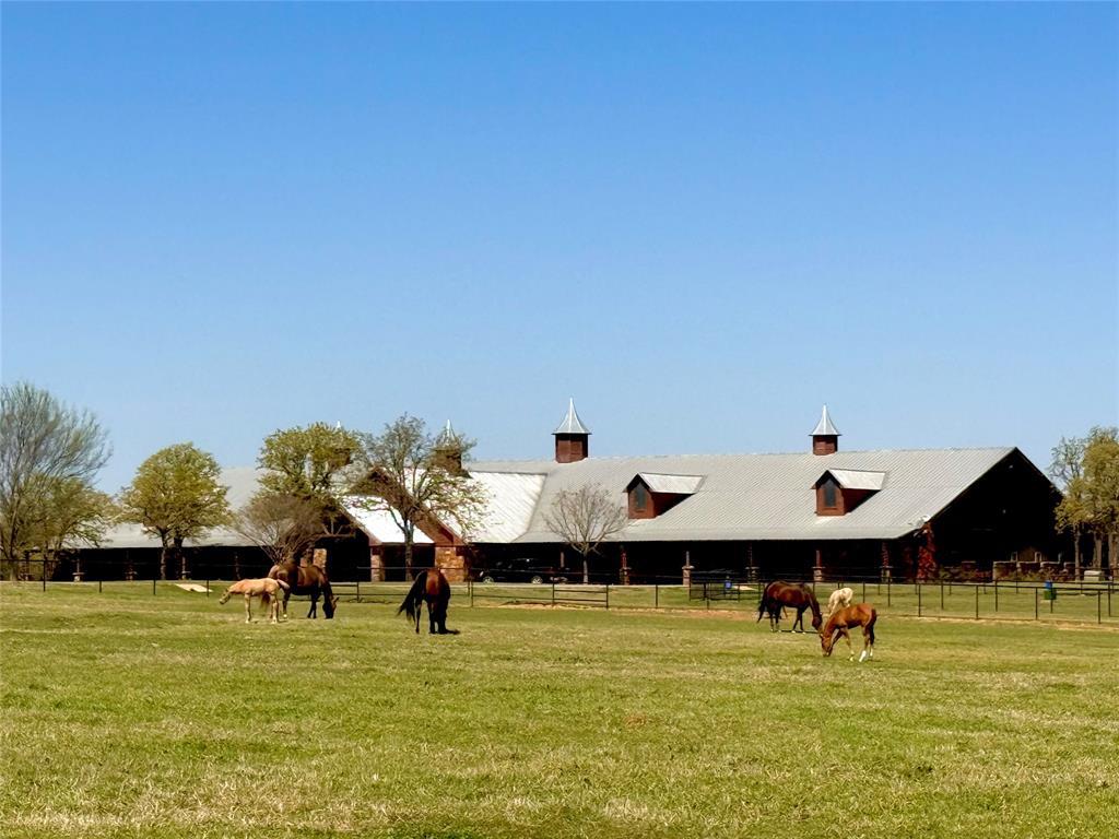 Rarely does such a unique, well designed WORLD CLASS equestrian facility grace the international real estate market. Spanning 132 LUSH ACRES, an iconic equestrian estate with a rich legacy and absolutely UNPARRALLED AMENITIES. High functioning infrastructure, lifestyle appeal, long term value and a REVENUE GENERATING ASSET. Behind the massive, elegant gates, discover a true PREMIER TEXAS MASTERPIECE with a 24,000 square foot MAIN BARN, 10,219 square foot EQUINE SPA BARN, 8 HORSE EURO-XISER, EQUINE NAUTILIS SALT WATER AQUATIC SYSTEM, AQUA LOW IMPACT TREADMILL, EQUINE THERAPY PLATE with RED LIGHT SOLARIUM, an amazing HEATED 115 foot EQUINE LANE POOL, 100 X 150 LIGHTED COVERED ARENA, with custom footing. OVERSIZED STALLS with AUTO WATERS and WASH STALLS. Main Barn has a nice one bedroom apartment. Barns have large LOUNGE, KITCHEN AND OFFICE AREAS, LAB ROOM, FEED ROOM plus beautiful, spacious RECEPTION AREA, FLEX SPACE and 4 WELLNESS ROOMS. 3,500 square foot MAINTENANCE BUILDING. Newly remodeled three bedroom, two bathroom GUEST HOUSE. The stunning MAIN RESIDENCE is 6,000 square feet, where artistry, design and luxury meet. Beautiful high end, one of a kind designers dream interior and finishes. Three oversized bedrooms with their own private elegant bathrooms plus extra guest bathrooms. One of a kind primary suite, including a custom fireplace with a luxurious attached bathroom.  An amazing chefs kitchen with a commercial range. Large basement and safe storm room. 2 LARGE PONDS one is an acre stocked with fish. Highly improved, gorgeous property completely fenced with pipe and non climb. 10 RUN IN SHELTERS with separate paddocks. Paved roads and drives throughout property. FIRST TIME ON THE MARKET, this unbelievable facility has been a RENOWNED, SUCCESSFUL, training, performance and equine wellness center for several years. Perfect for any discipline. A RARE OPPORTUNITY to own a fully developed, turn key compound of this caliber. Excellent location. MAKE IT YOURS!