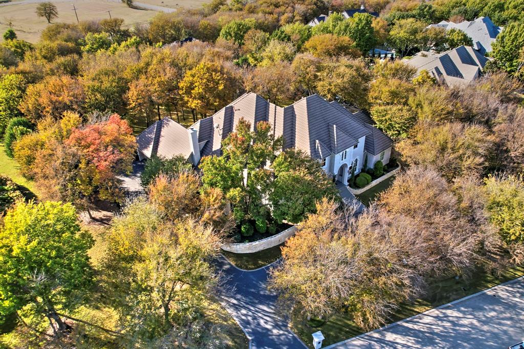 Experience a true Mediterranean masterpiece set on an expansive, private lot in the prestigious community of Mira Vista. This exceptional residence showcases unparalleled finishes, superior craftsmanship, and meticulous attention to detail making it an absolute must-see. Step into a grand foyer that sets the tone for the home’s elegance, flanked by an impressive dining room, refined study, and soaring floor-to-ceiling windows that frame stunning views of the pool and backyard oasis. Designed for both comfort and sophistication, the kitchen seamlessly flows into the inviting living room, creating an ideal space for everyday living and entertaining. The luxurious primary suite offers a serene retreat, complete with a spacious sitting area, wet bar, double-sided fireplace, oversized walk-in closet, and private outdoor access. The home features two bedrooms on the main level, including the primary, and three additional bedrooms upstairs, each with its own private bath. The upstairs game room is a standout, featuring a built-in bar and a balcony overlooking the sparkling pool and beautifully landscaped grounds.
