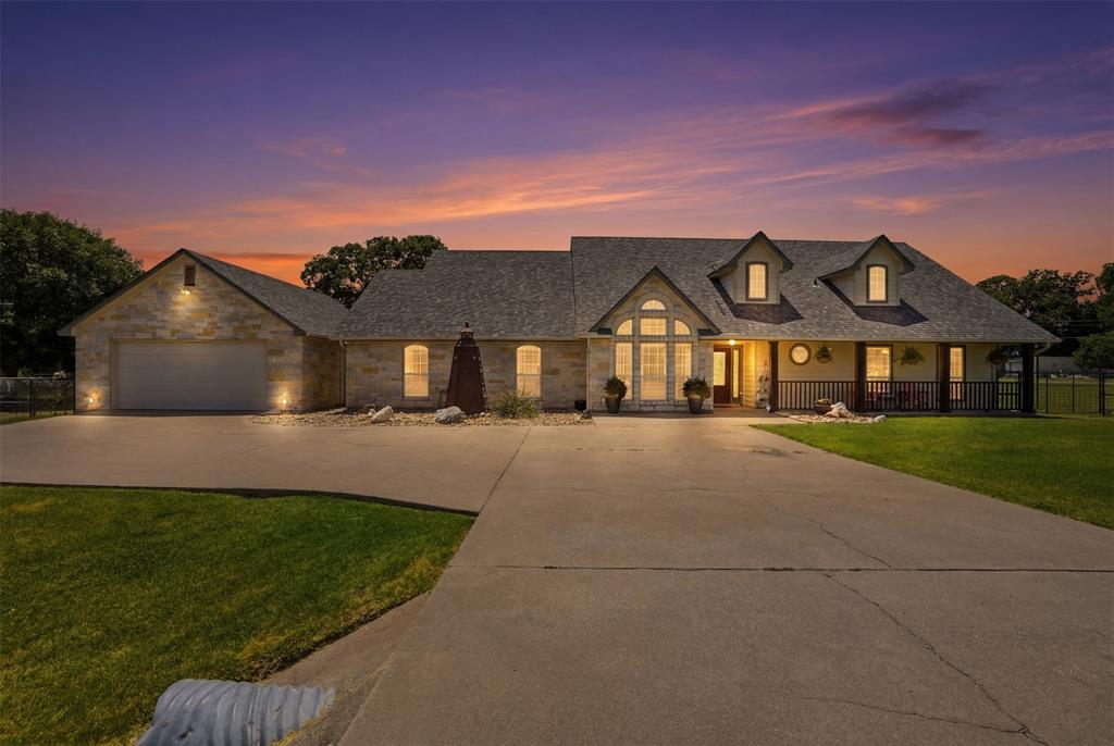 Welcome home to this beautifully updated 3-bedroom, 2.5-bath home featuring a huge bonus room currently used as a 4th bedroom, offering flexible space for guests, a game room, home office or media room. Situated on a spacious 0.51-acre lot just outside the city limits, you'll enjoy the added benefit of no city taxes & no HOA while still being conveniently close to shopping, dining, schools & major conveniences. Inside, you'll find a warm & inviting living room centered around a wood-burning fireplace with a raised brick hearth, plus two dining areas perfect for everyday living & entertaining. The kitchen is beautifully appointed with built-in stainless steel appliances and granite countertops plus island, providing both style & functionality. The remodeled bathrooms add a modern touch, including the impressive primary ensuite featuring a separate soaking tub, walk-in shower & vanity with elegant quartz countertops. Car enthusiasts, hobbyists or those needing extra storage will appreciate the oversized 4-car tandem garage. With its generous lot, updated interior, versatile floor plan & desirable location outside the city limits, this home truly offers the best of space, comfort & convenience & a storm room for your safety. Welcome home!