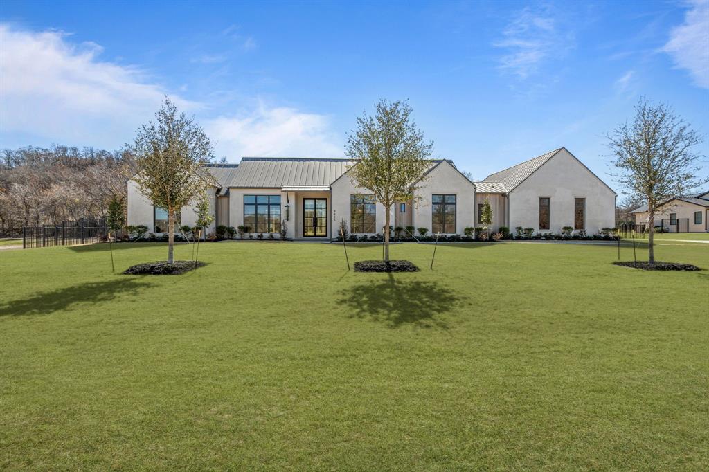 Olerio Homes presents an extraordinary new construction in the prestigious, gated community of Montrachet. Nestled on a sprawling 1.02-acre lot, this 5,775 SF estate offers an unparalleled blend of sophistication, comfort, and security, with 24-hour gated access ensuring the utmost privacy. Thoughtfully designed with high-end finishes throughout, this stunning residence features a spacious main floor, where formal and casual dining areas create an inviting atmosphere for entertaining. A versatile sitting area, enclosed by elegant French doors, seamlessly blends style and function, while a discreet workspace, hidden behind pocket doors, provides a private retreat for productivity. A guest suite with an adjoining living area—or an optional game room with a wet bar—offers flexibility to suit your lifestyle. The open-concept gourmet kitchen, complete with a separate prep kitchen and top-tier appliances, flows effortlessly into the expansive living area, where built-ins, a fireplace, and walls of glass frame breathtaking backyard views. A powder bath and laundry room complete the first level. Upstairs, two additional ensuite bedrooms and a loft-style living area provide luxurious comfort and privacy for family and guests alike. Designed for both elegance and functionality, this exceptional Olerio Homes residence redefines luxury living in one of Fort Worth’s most coveted communities. Experience the unparalleled lifestyle that Montrachet has to offer—where serenity, exclusivity, and timeless design come together in perfect harmony.