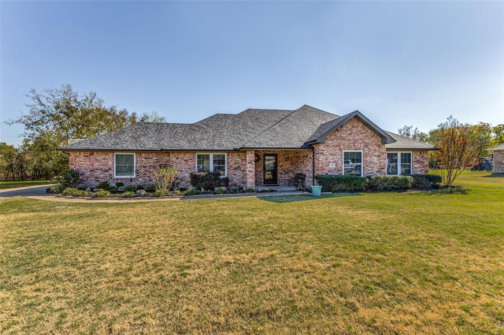Situated on a large lot over HALF AN ACRE WITH WOODED CREEK VIEW in back. One story home that has been well maintained by the original owners. Boasting a host of UPDATES including flooring, new carpet & paint, all windows, kitchen counters, appliances & backsplash, primary bathroom & more. This beautiful home is set comfortably back from the street with a long driveway for extra parking. The lovely flower beds & front porch add to the overall curb appeal. Inside, the home features quality wood look floors in the living area, dining room, kitchen, breakfast & laundry rooms. The kitchen has granite counters & stone backsplash plus upper end appliances. The crisp & modern paint colors tie the spaces together perfectly. Looking out to the backyard & seeing green grass & a tree lined creek is a welcome sight. Primary bedroom is spacious enough for all your furniture, it also has an updated bathroom. The home is close to shopping, dining & entertainment in Rockwall, Fate & Royse City. No HOA