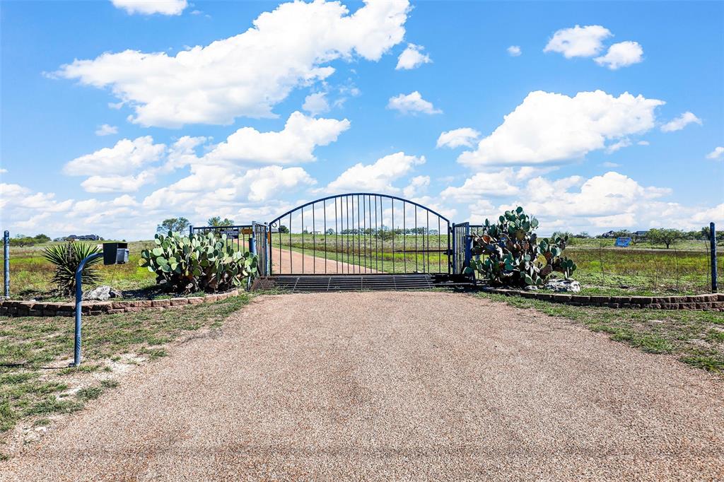 This stunning 3-bedroom, 2.5-bath home sits on 156 acres at one of the highest points in Parker County, within the prestigious Aledo ISD. The property offers breathtaking panoramic views, a sparkling pool, and a large shop for projects or storage. Perfect for ranching or livestock, it includes abundant water resources for animals. The home blends modern comfort with rustic charm, featuring spacious living areas and a well-appointed kitchen. An exclusive golf course is coming soon, adding incredible future value to this unique property. Whether you're seeking a peaceful retreat, a working ranch, or an investment with recreational appeal, this expansive estate offers it all. Don't miss this rare opportunity to own a prime piece of land with endless potential in one of Texas’ most sought-after areas.