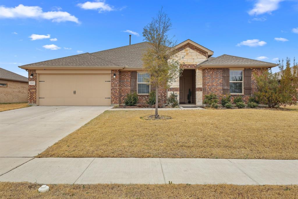 This inviting 4-bedroom, 2-bath home offers an easy, open-concept layout that’s great for everyday living and entertaining. The split-bedroom floor plan provides a private primary suite with dual sinks and a spacious walk-in shower, while three additional bedrooms share a generously sized secondary bath. Wood-look flooring flows through the main living areas, complemented by granite countertops and rich, warm-toned cabinetry. The kitchen features stainless steel appliances, a gas range, large island, and walk-in pantry. Step outside to a spacious backyard with a covered patio - perfect for relaxing or hosting friends. Plus, enjoy the added bonus of open green space across the street with no homes in front, ideal for play, gatherings, or extra parking. Smart-home features, tankless water heater, sprinkler system, partial gutters, and garage door opener complete the package.